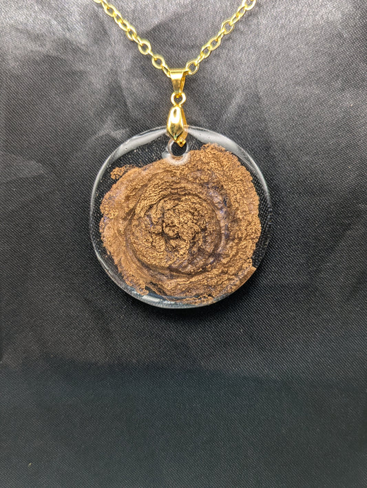 Gold Swirl Resin Circle pendant on a gold pinch bail & gold plated metal chain.