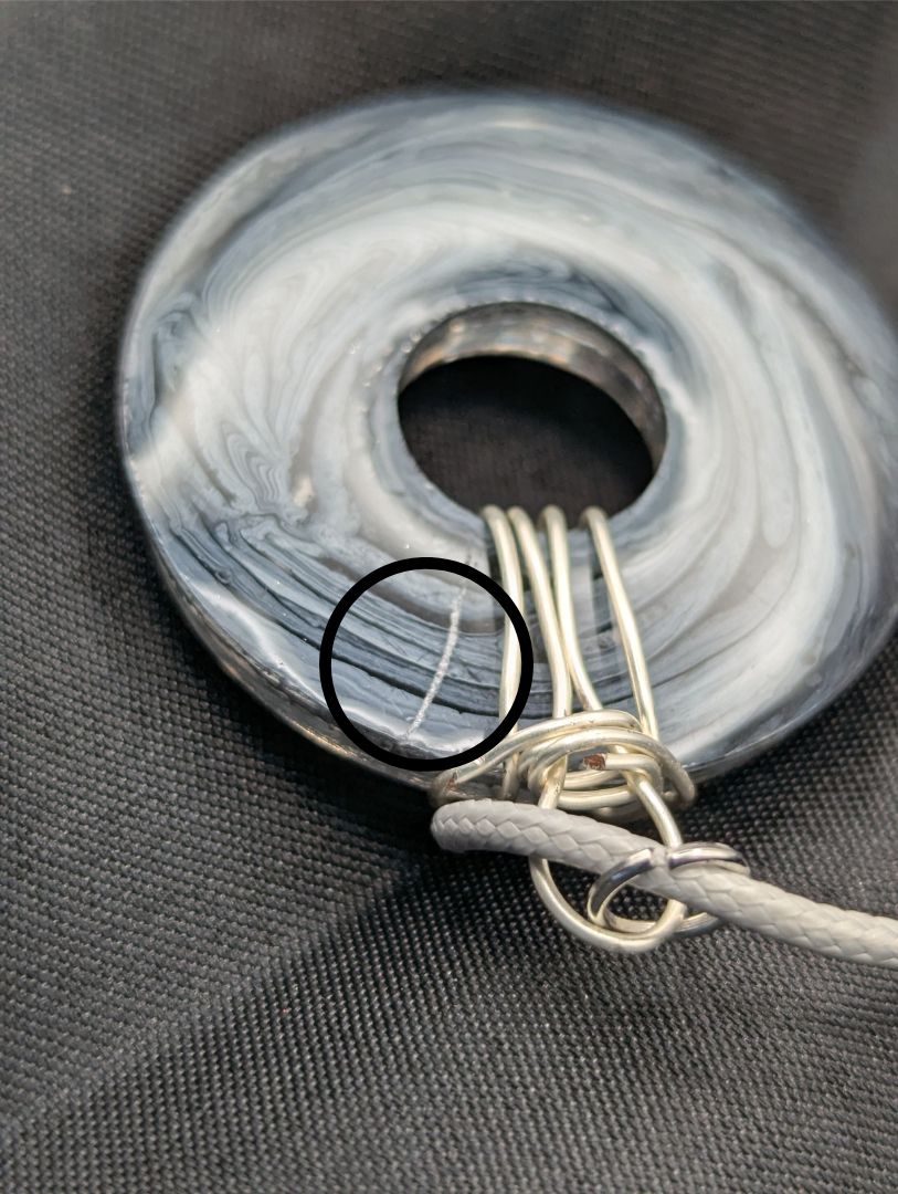 Wire Wrapped Donut Resin Pendant Necklace - Petri Effect with shades of black, white, & dark smokey bluish gray swirls. Resin Necklace on a waxed cotton cord.