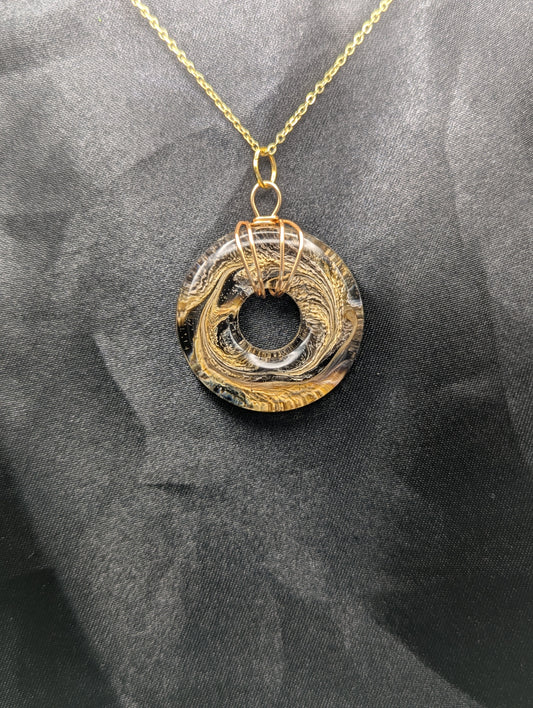 Wire Wrapped Donut Resin Pendant Necklace - Petri Effect with shades of brown & yellow swirls. Resin Necklace on a gold plated metal chain.