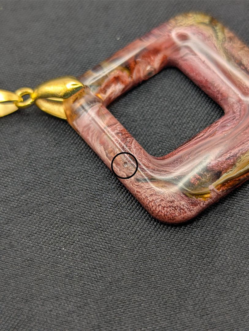 Pink & brown swirl square pendant necklace on a gold plated metal chain