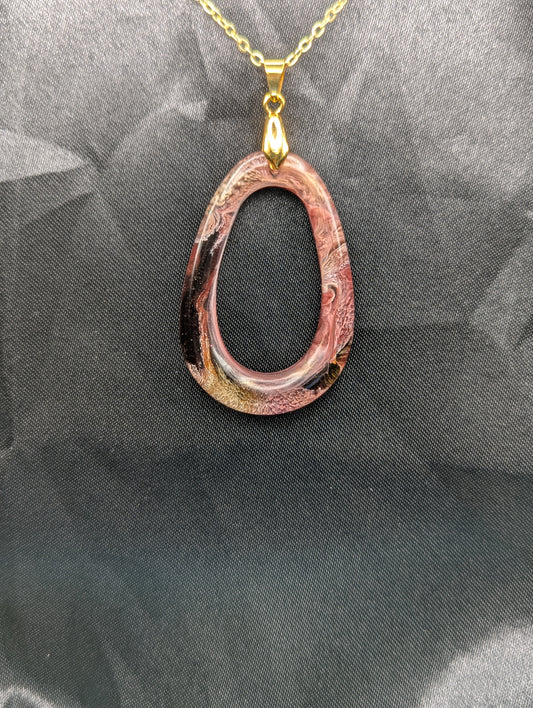 Pink & Orange Zero Shaped Resin Pendant Necklace - Petri Effect with shades of pink, orange, & red swirls. Resin Necklace on a gold pinch bail & gold plated metal chain.