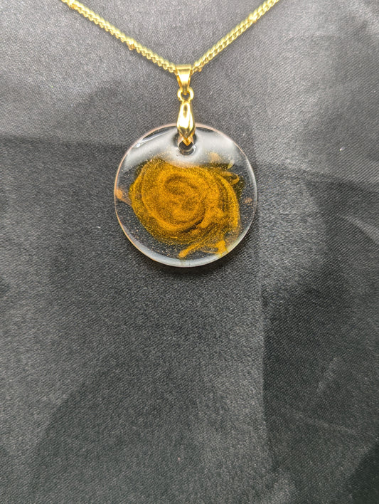 Yellow & Orange Swirl Circle Resin Pendant with a gold pinch bail on a gold plated metal chain.