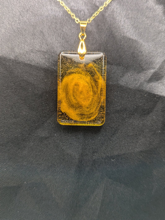 Yellow & Orange Swirl Rectangle Resin Pendant on a gold pinch bail & gold plated metal chain.
