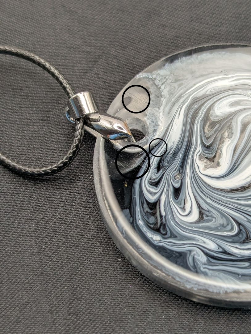 Black & White Swirl Circle Pendant on a silver pinch bail & waxed cotton cord. Resin Circle Jewelry Pendant with Petri Effect.