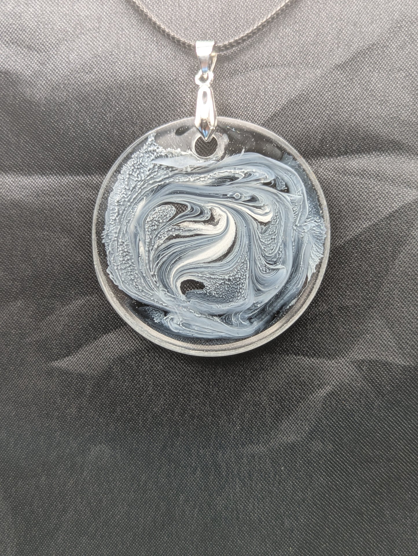 Black & White Swirl Circle Pendant on a silver pinch bail & waxed cotton cord. Resin Circle Jewelry Pendant with Petri Effect.