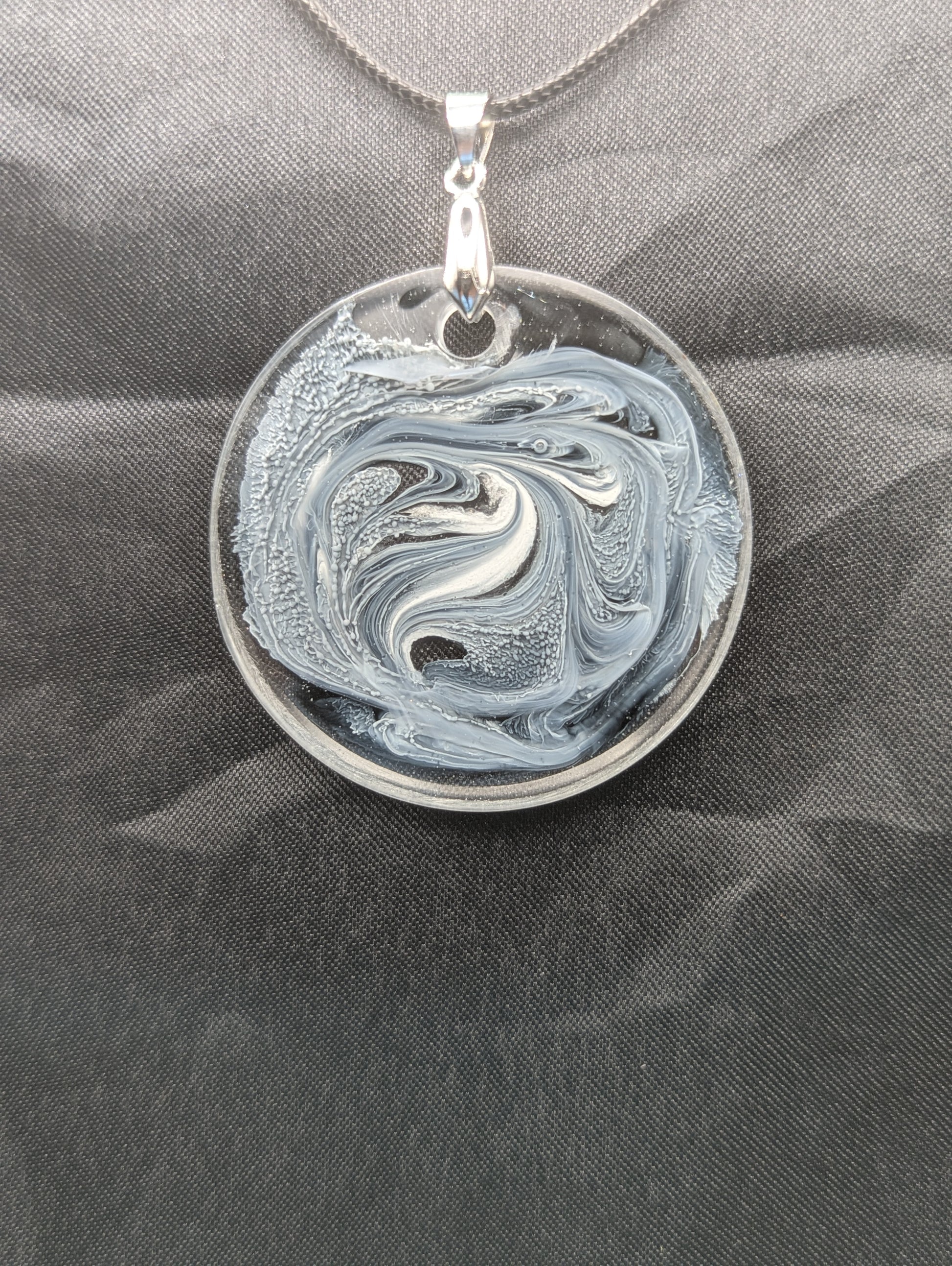 Black & White Swirl Circle Pendant on a silver pinch bail & waxed cotton cord. Resin Circle Jewelry Pendant with Petri Effect.