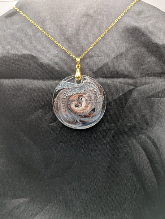 Brown Swirl Circle Pendant with shades of brown, red, & black on a gold pinch bail & golden stainless steel chain. Resin Circle Jewelry Pendant with Petri Effect.