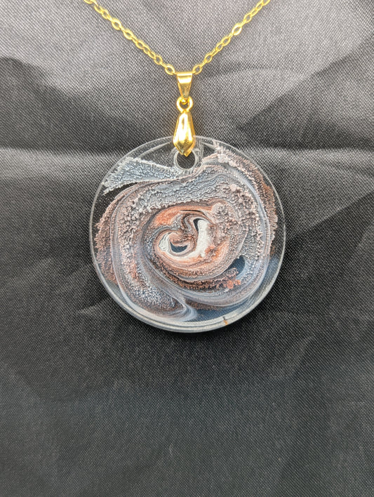 Brown Swirl Circle Pendant with shades of brown, red, & black on a gold pinch bail & golden stainless steel chain. Resin Circle Jewelry Pendant with Petri Effect.