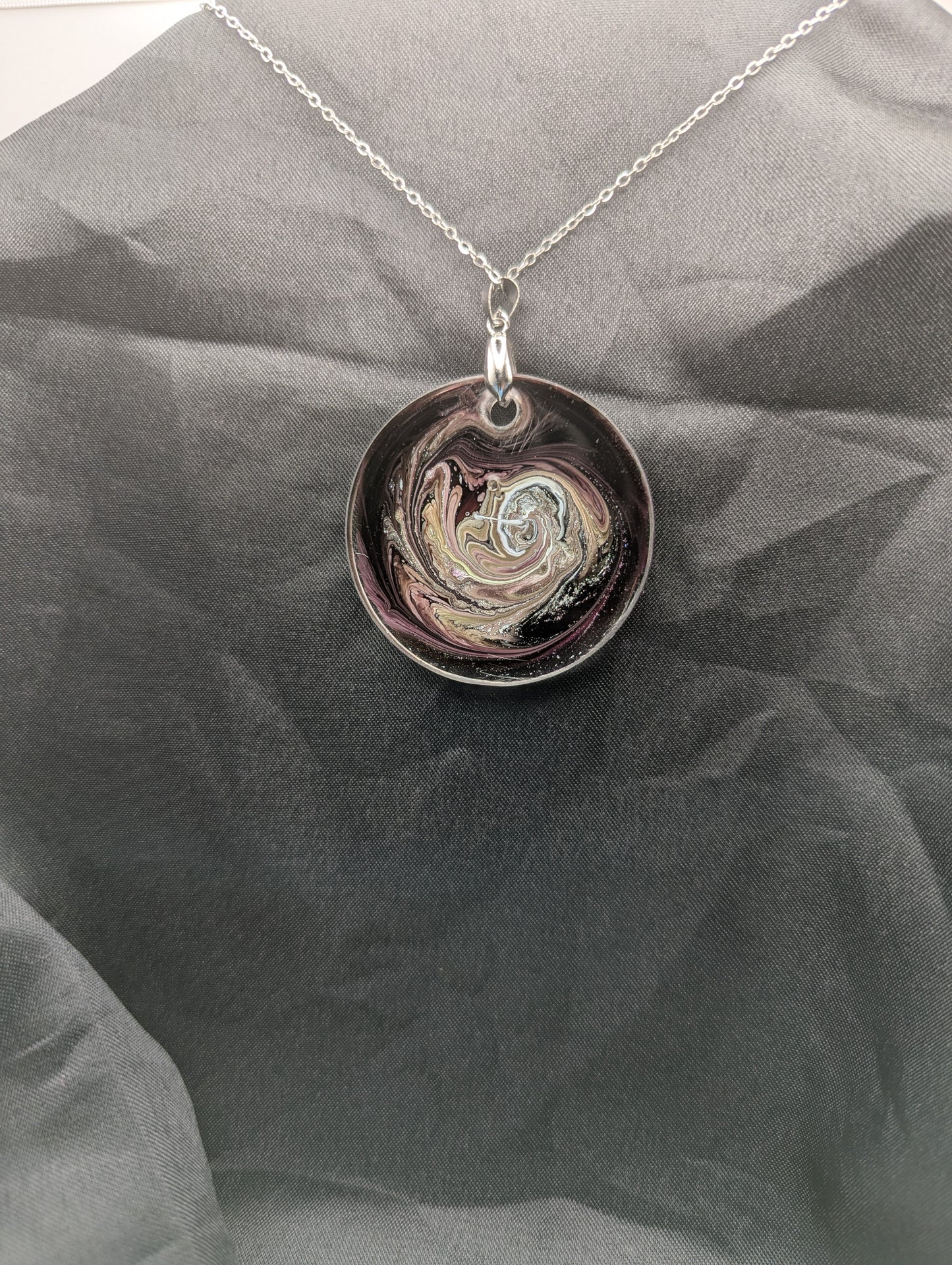Back view of Purple Swirl Circle Pendant with shades of purple, yellow, & black on a silver pinch bail & silver plated stainless steel chain. Resin Circle Jewelry Pendant with Petri Effect.