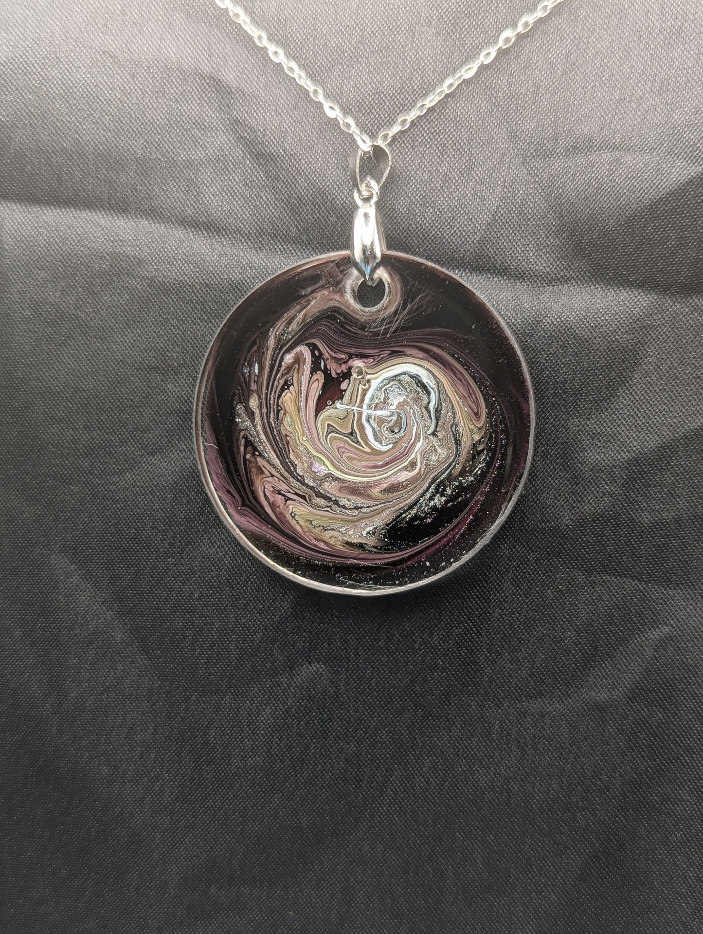 Back view of Purple Swirl Circle Pendant with shades of purple, yellow, & black on a silver pinch bail & silver plated stainless steel chain. Resin Circle Jewelry Pendant with Petri Effect.