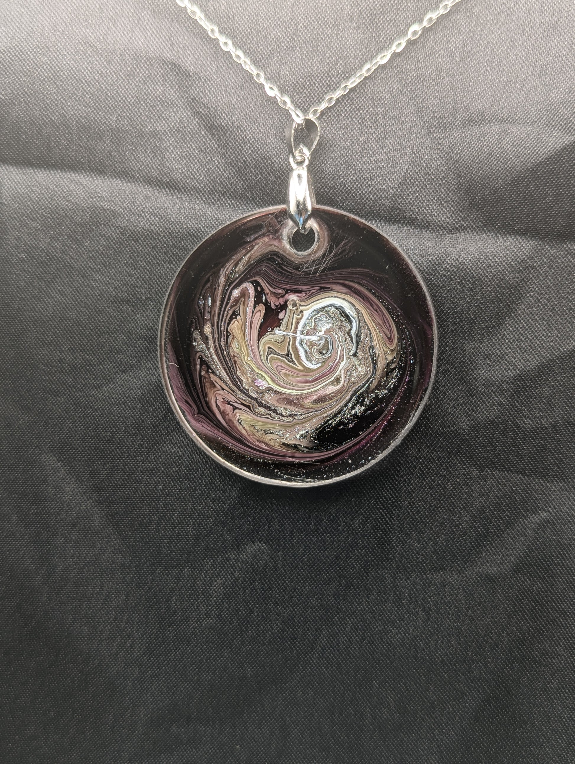 Back view of Purple Swirl Circle Pendant with shades of purple, yellow, & black on a silver pinch bail & silver plated stainless steel chain. Resin Circle Jewelry Pendant with Petri Effect.