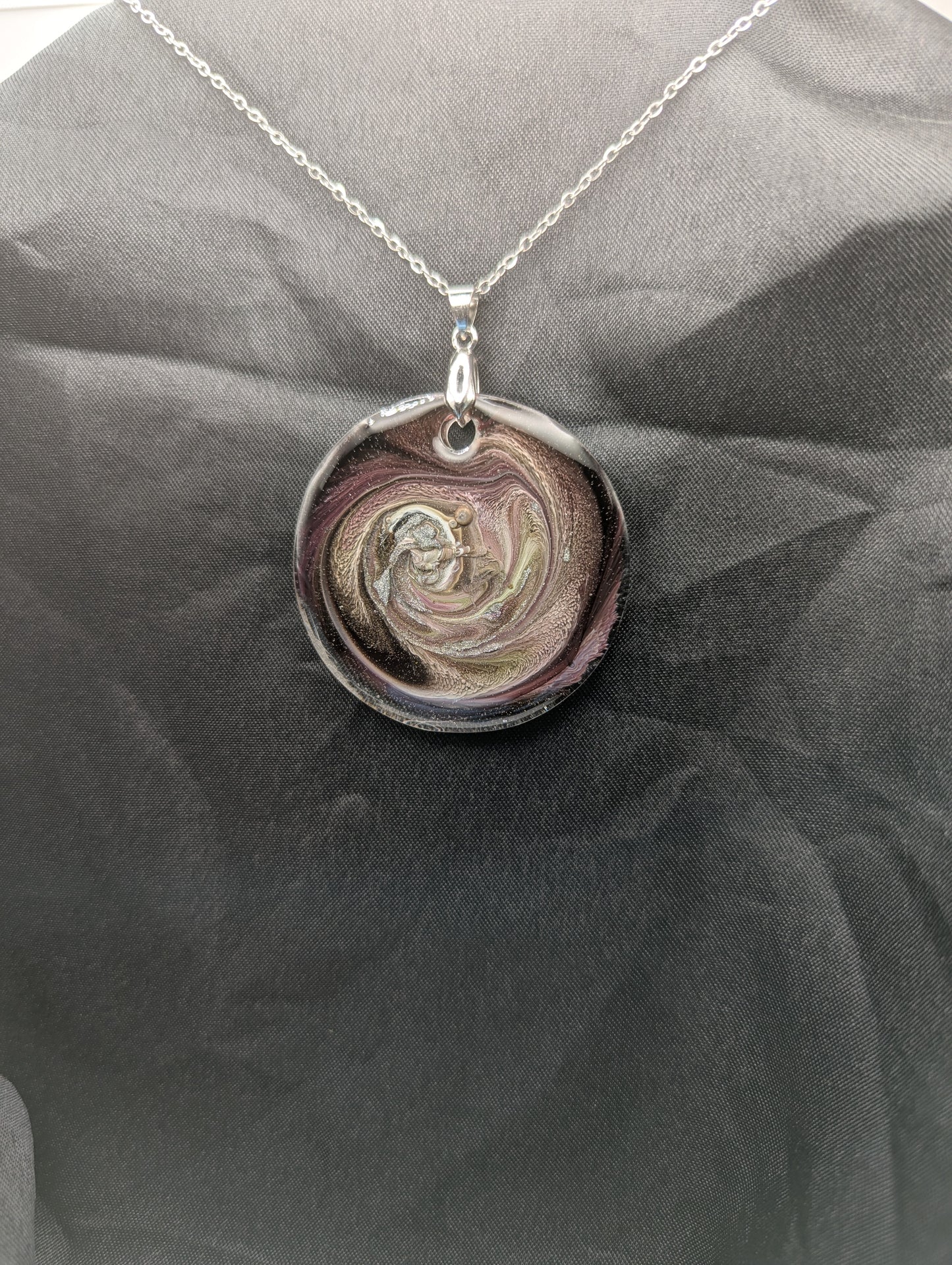 Purple Swirl Circle Pendant with shades of purple, yellow, & black on a silver pinch bail & silver plated stainless steel chain. Resin Circle Jewelry Pendant with Petri Effect.