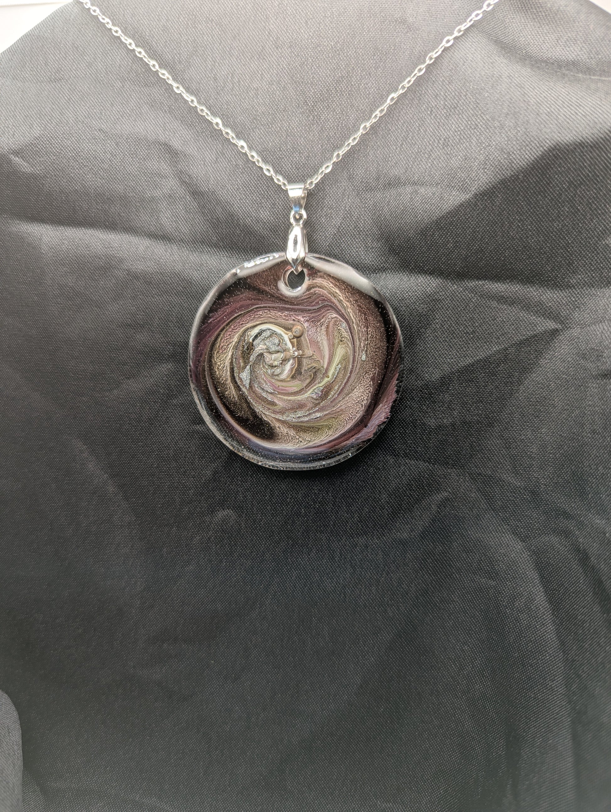 Purple Swirl Circle Pendant with shades of purple, yellow, & black on a silver pinch bail & silver plated stainless steel chain. Resin Circle Jewelry Pendant with Petri Effect.