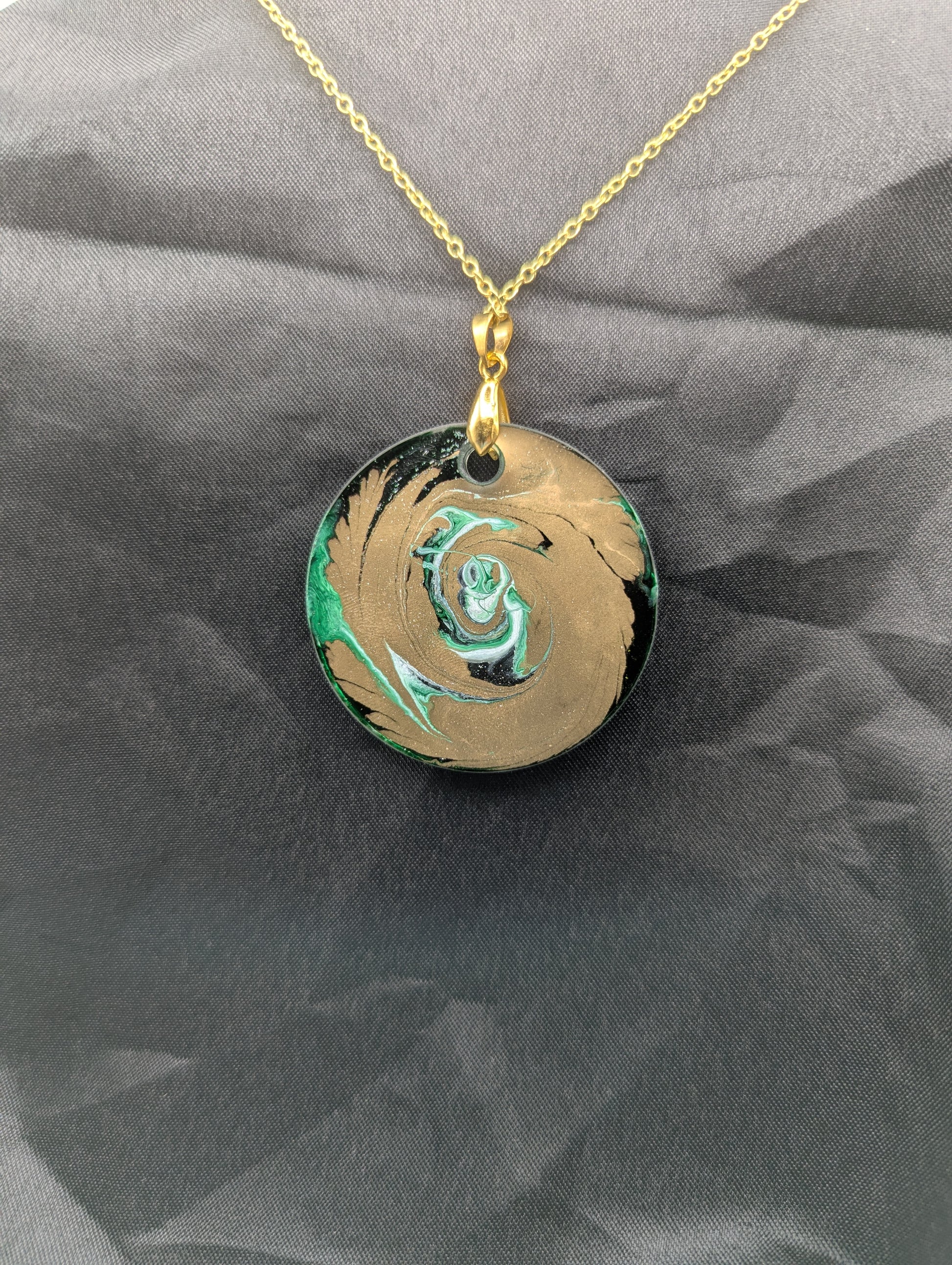 Back view of Green & Gold Swirl Circle Pendant on a gold pinch bail & gold plated stainless steel chain. Resin Circle Jewelry Pendant with Petri Effect.