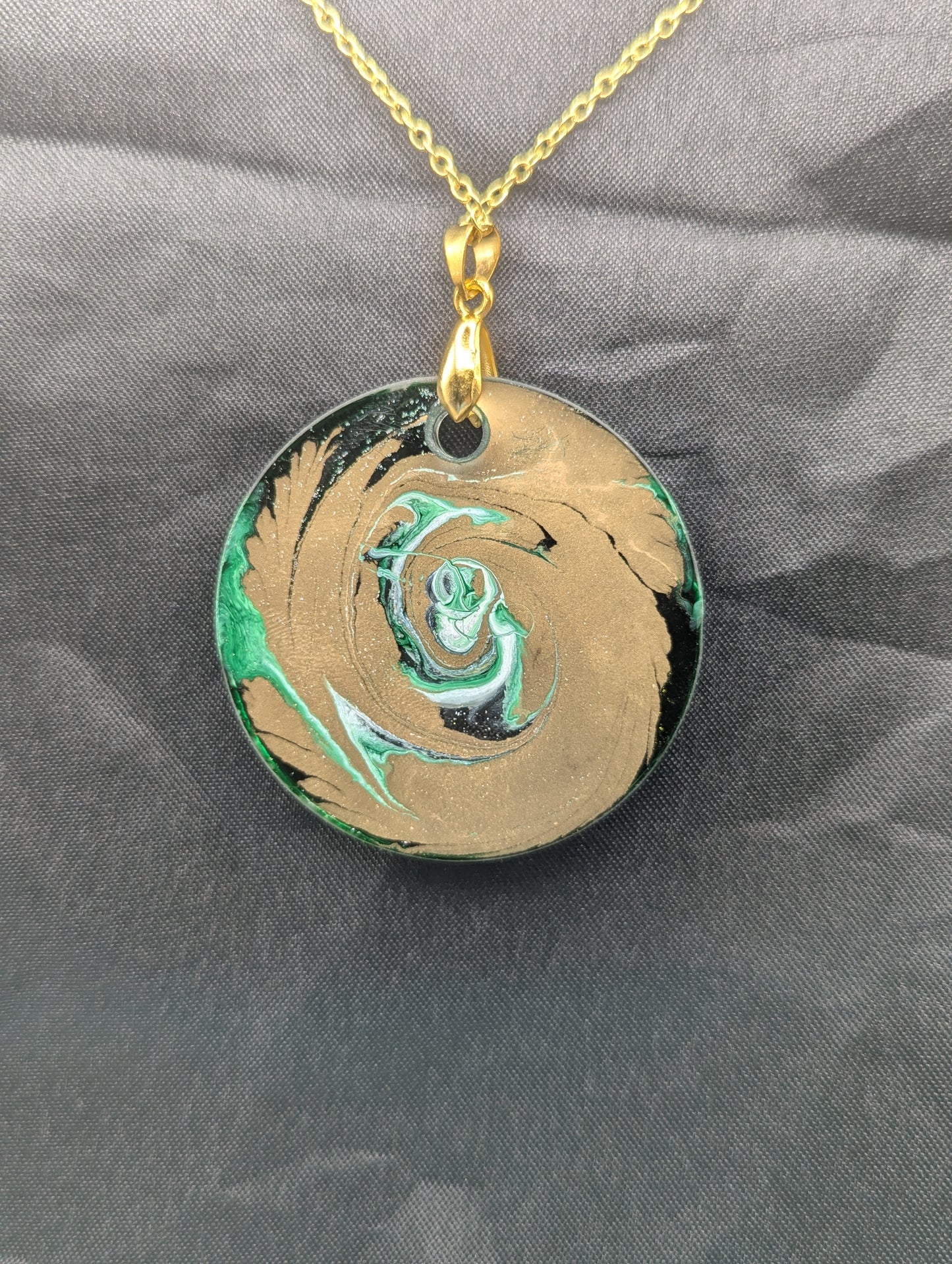 Back view of Green & Gold Swirl Circle Pendant on a gold pinch bail & gold plated stainless steel chain. Resin Circle Jewelry Pendant with Petri Effect.