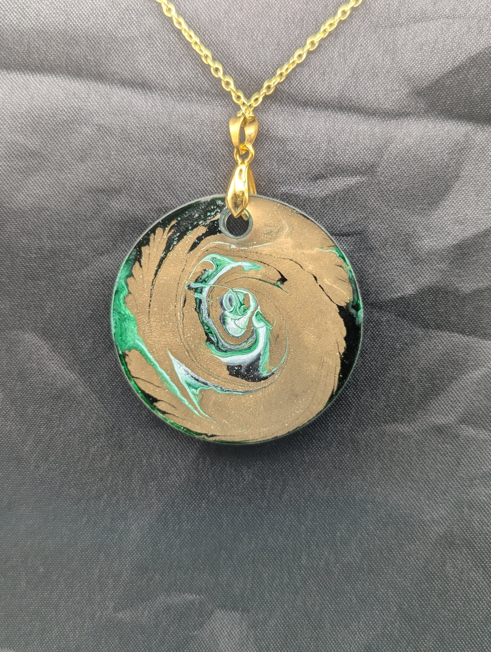 Back view of Green & Gold Swirl Circle Pendant on a gold pinch bail & gold plated stainless steel chain. Resin Circle Jewelry Pendant with Petri Effect.
