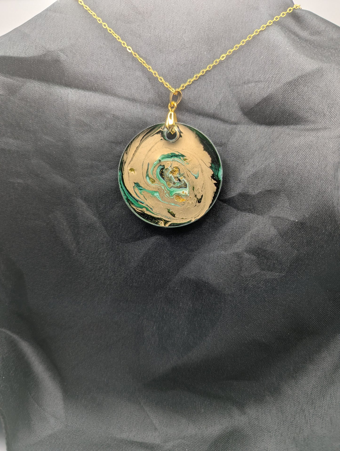 Back view of Green & Gold Swirl Circle Pendant on a gold pinch bail & gold plated metal chain. Resin Circle Jewelry Pendant with Petri Effect.