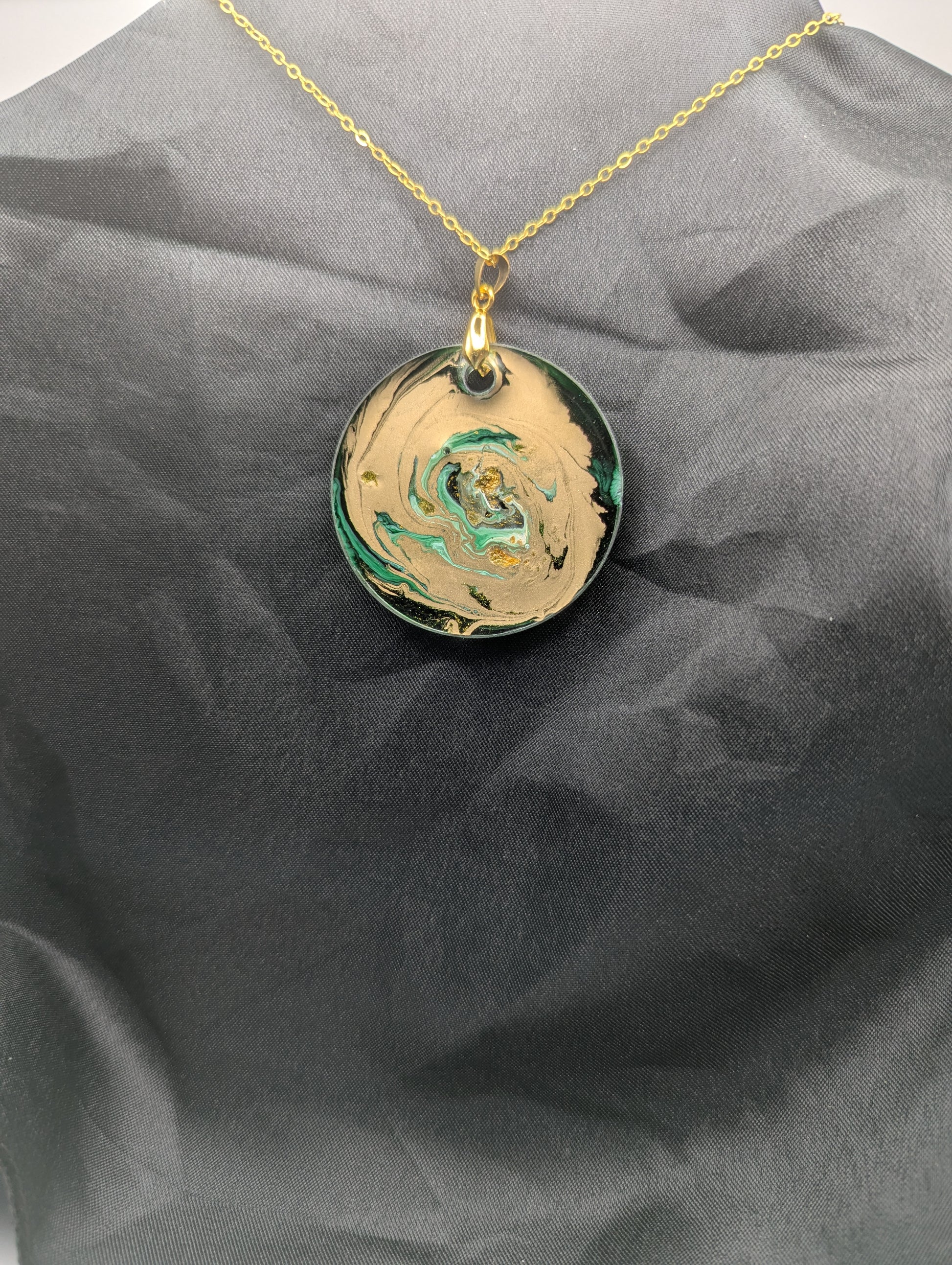 Back view of Green & Gold Swirl Circle Pendant on a gold pinch bail & gold plated metal chain. Resin Circle Jewelry Pendant with Petri Effect.