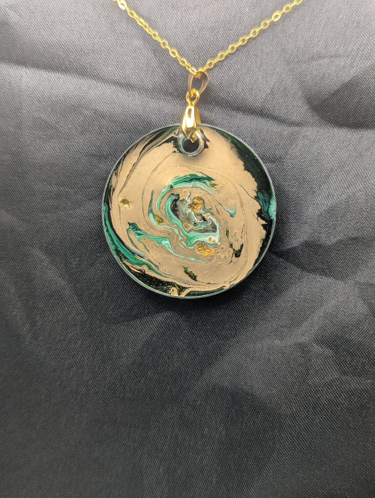 Back view of Green & Gold Swirl Circle Pendant on a gold pinch bail & gold plated metal chain. Resin Circle Jewelry Pendant with Petri Effect.