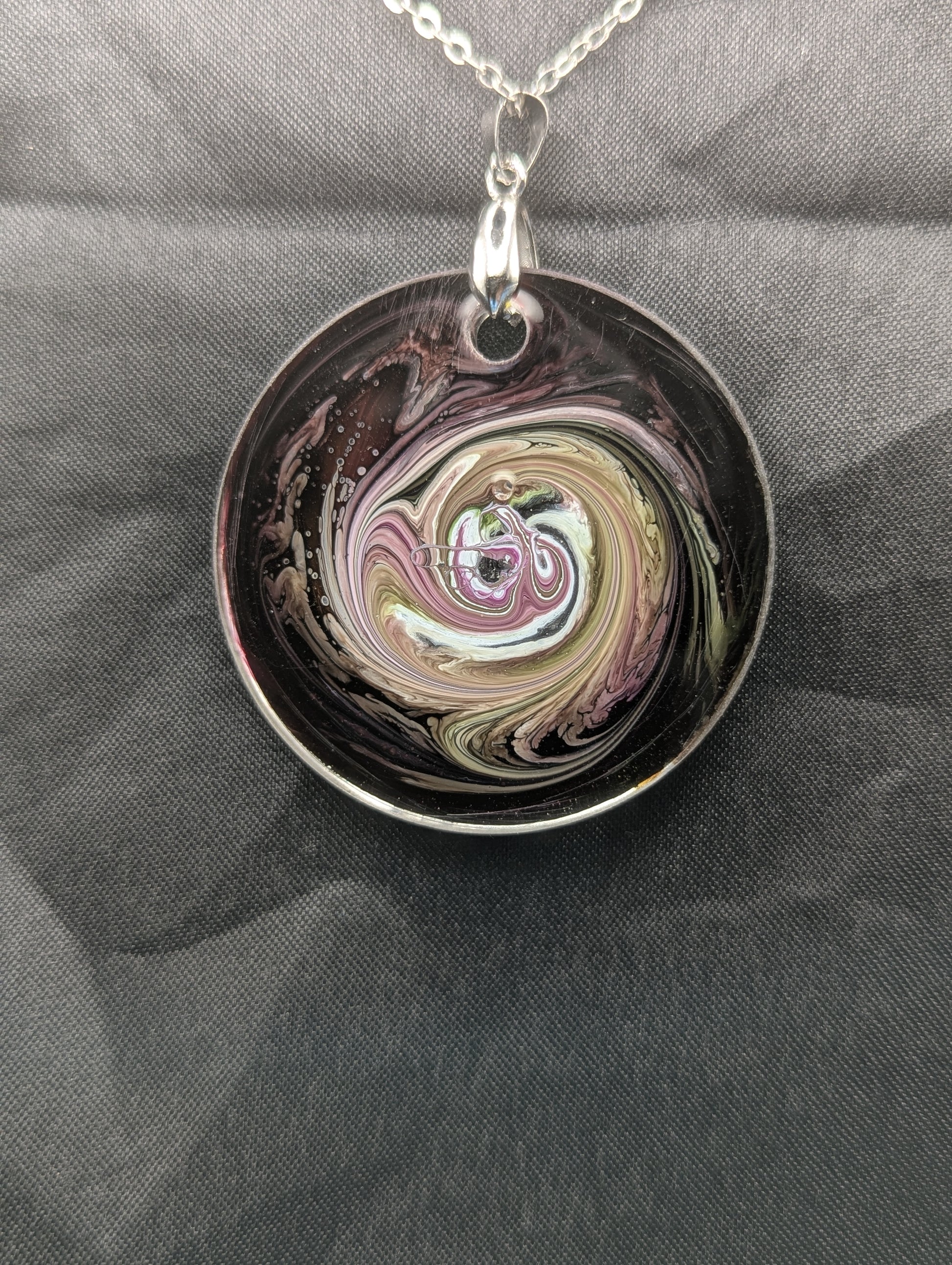 Back view of Purple & Yellow Swirl Circle Pendant on a silver pinch bail & stainless steel chain. Resin Circle Jewelry Pendant with Petri Effect.