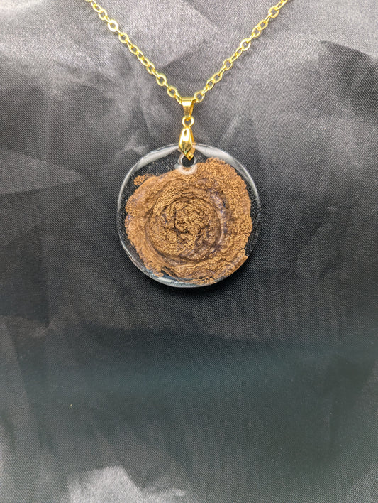Gold Swirl Resin Circle pendant on a gold pinch bail & gold plated metal chain.