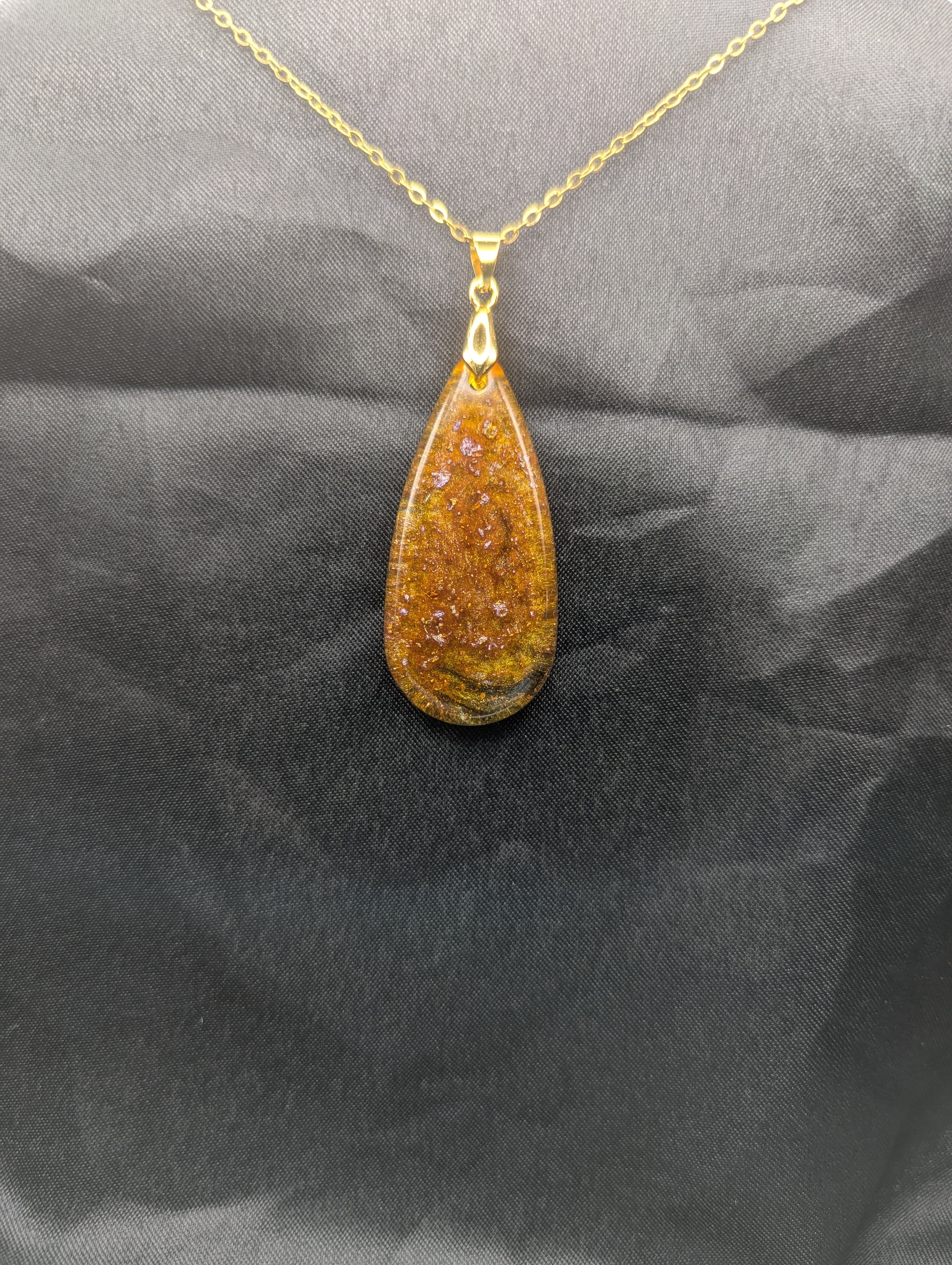 Yellow & Purple colored Teardrop Resin Pendant necklace with a gold pinch bail on a gold plated metal chain.