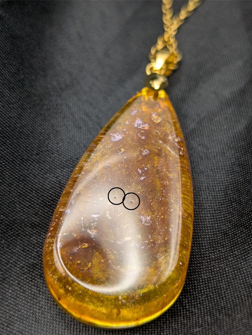 Yellow & Purple colored Teardrop Resin Pendant necklace with a gold pinch bail on a gold plated metal chain.