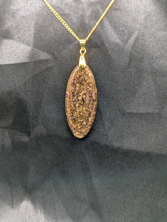 Rich Gold Swirl with dots of purple Ellipse Resin Pendant on a gold pinch bail and a gold plated metal chain.