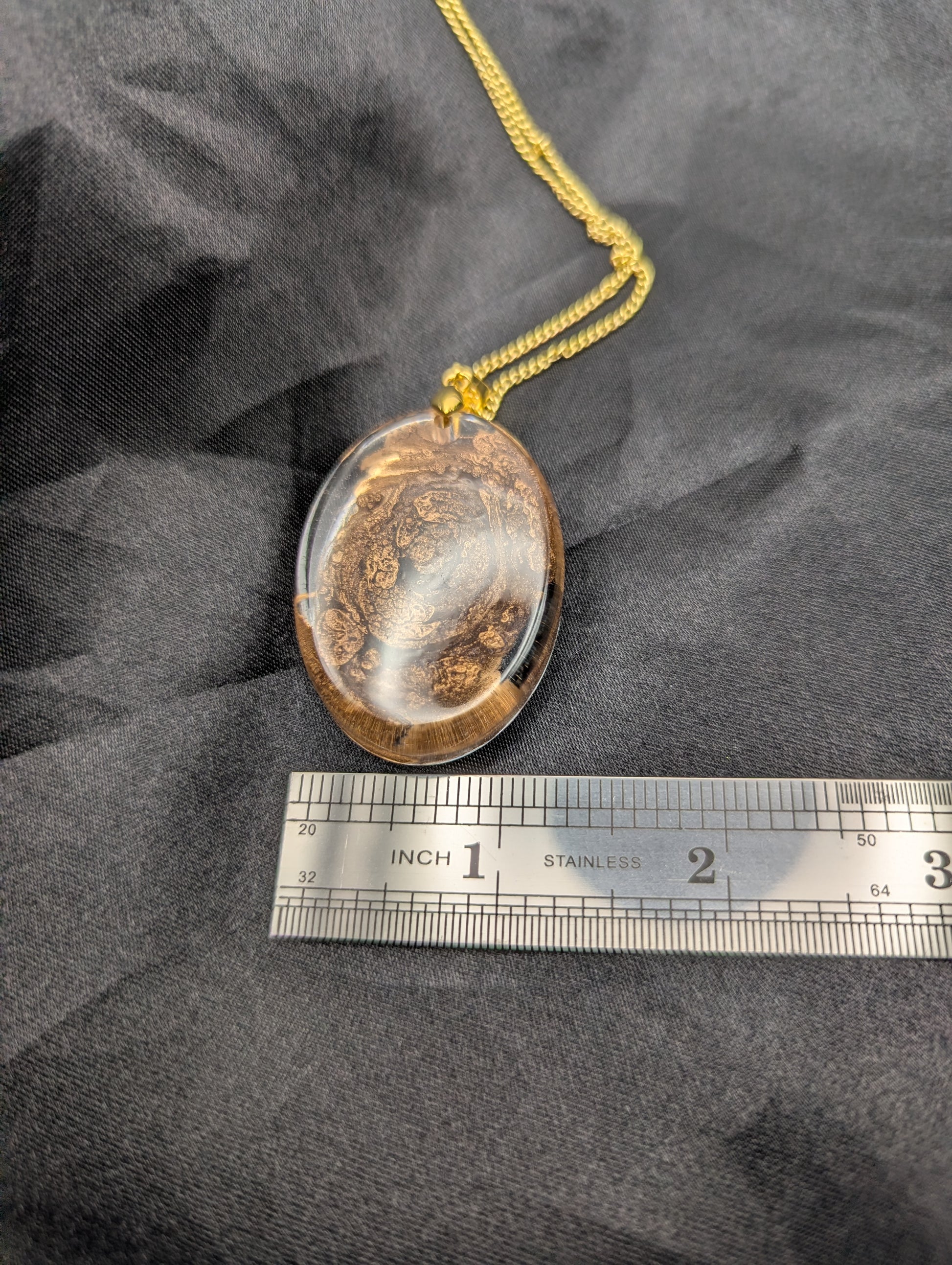 Size example pic of pendant size in inches, showing pendant is about 1.25 inches wide.