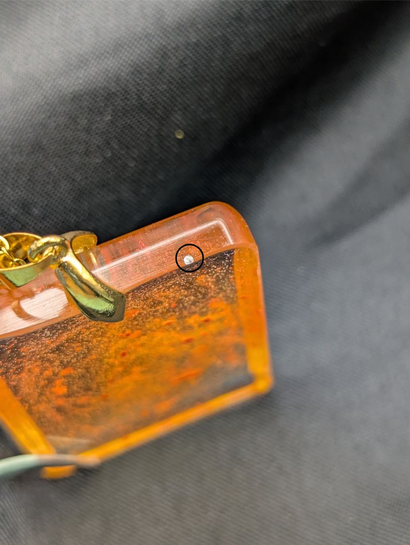 Yellow & Orange rectangle resin pendant necklace with a gold pinch bail on a gold plated metal chain.