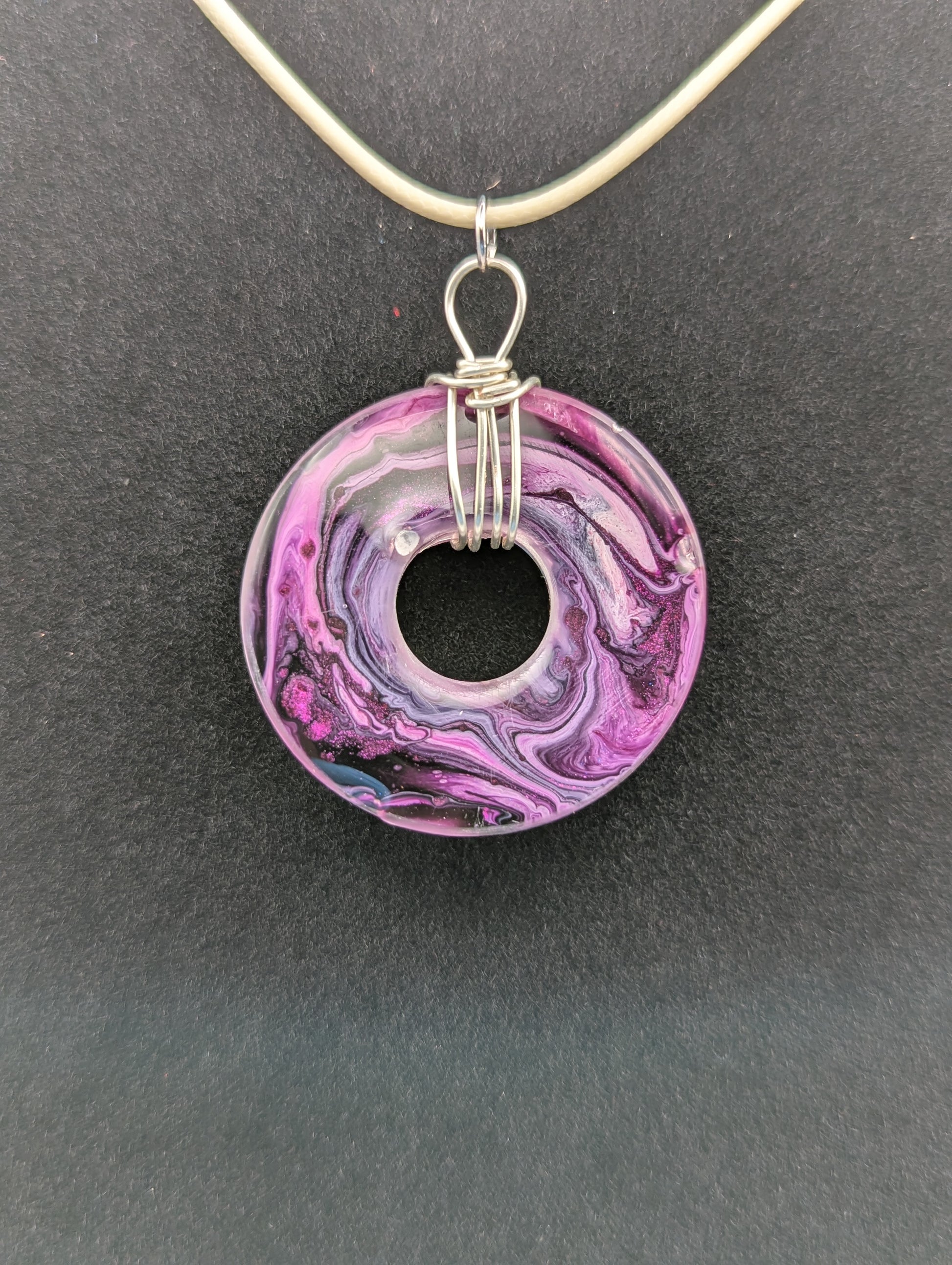 Wire Wrapped Donut Resin Pendant Necklace - Petri Effect with shades of purple, pink, & red swirls. Resin Necklace on a waxed cotton cord.