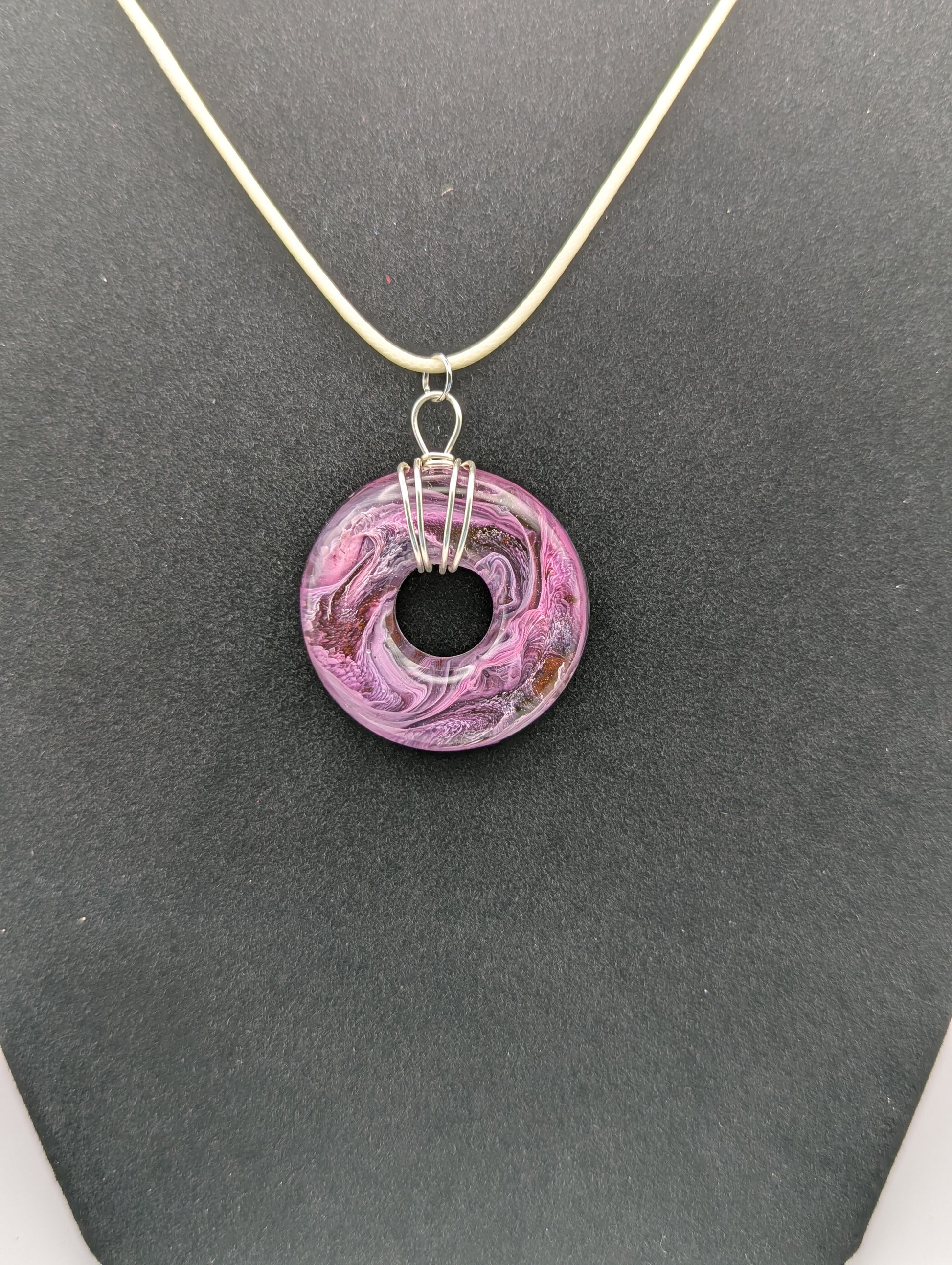 Wire Wrapped Donut Resin Pendant Necklace - Petri Effect with shades of purple, pink, & red swirls. Resin Necklace on a waxed cotton cord.