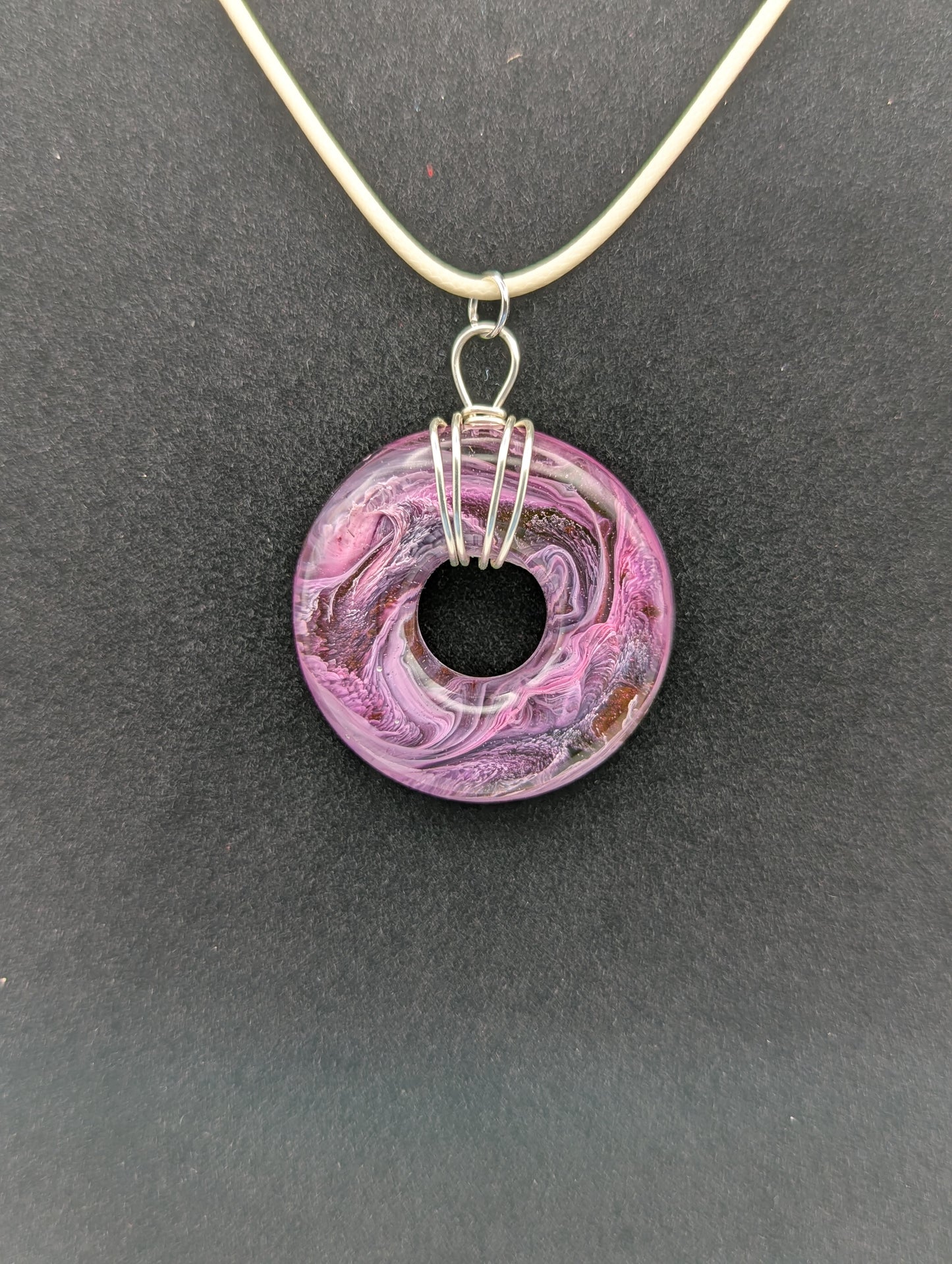 Wire Wrapped Donut Resin Pendant Necklace - Petri Effect with shades of purple, pink, & red swirls. Resin Necklace on a waxed cotton cord.