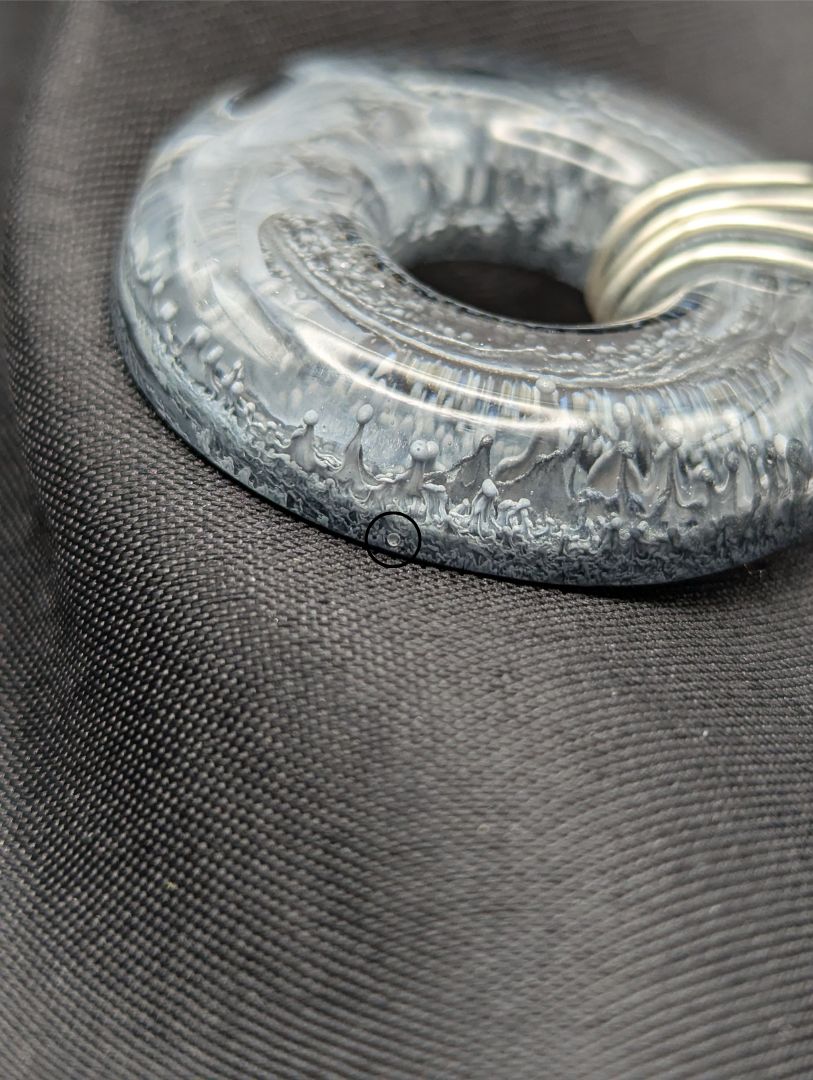 Wire Wrapped Donut Resin Pendant Necklace - Petri Effect with shades of black, white, & dark smokey bluish gray swirls. Resin Necklace on a waxed cotton cord.