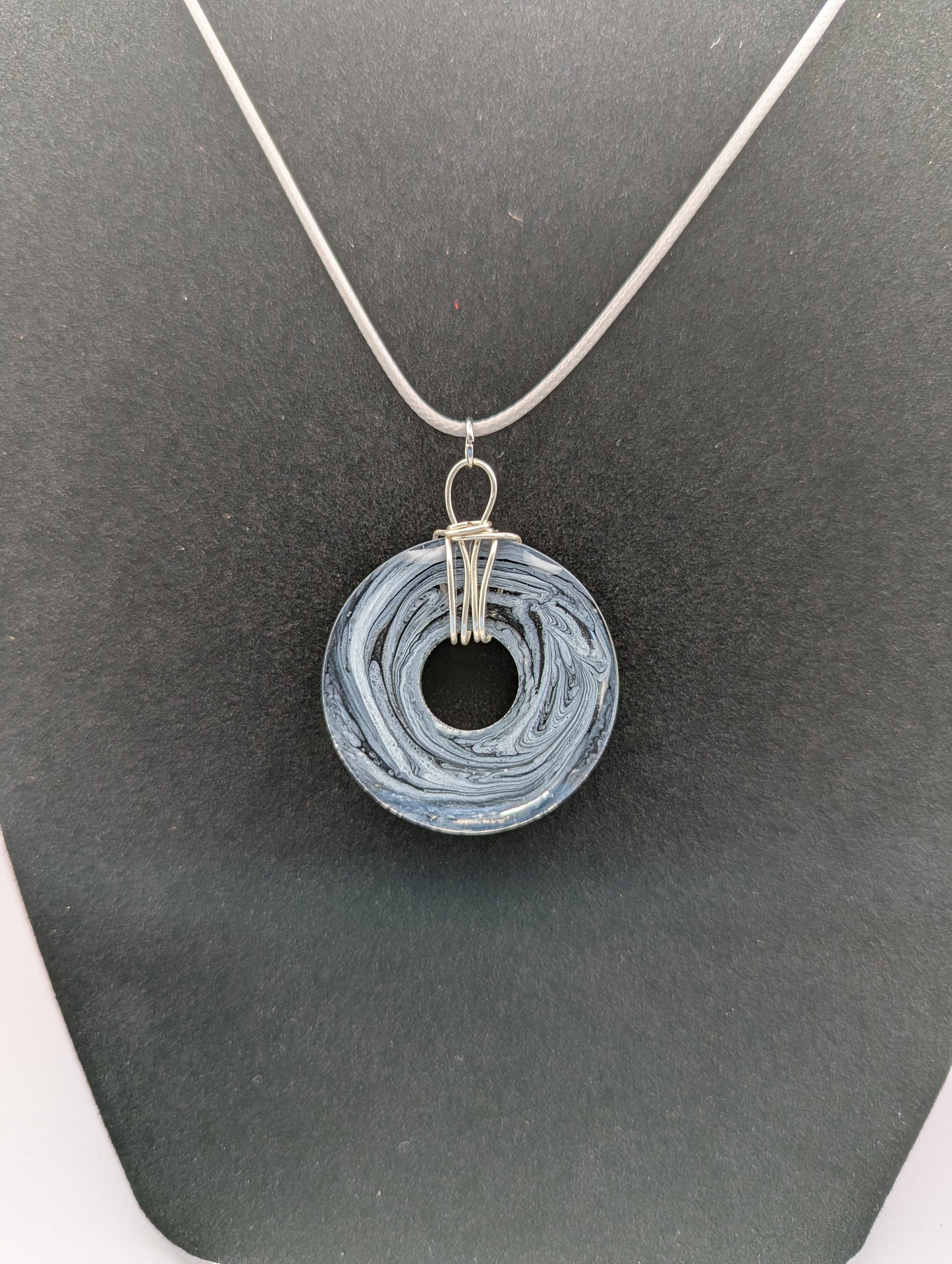 Back View of Wire Wrapped Donut Resin Pendant Necklace - Petri Effect with shades of black, white, & dark smokey bluish gray swirls. Resin Necklace on a waxed cotton cord. 