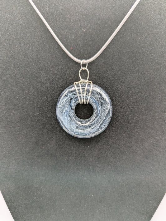 Wire Wrapped Donut Resin Pendant Necklace - Petri Effect with shades of black, white, & dark smokey bluish gray swirls. Resin Necklace on a waxed cotton cord.