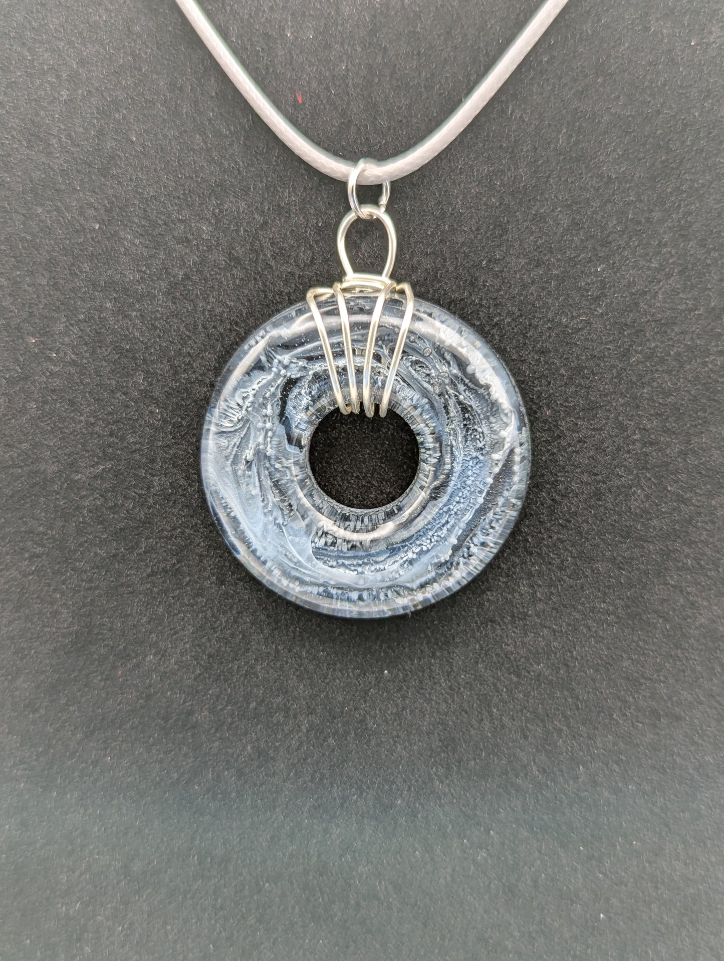Wire Wrapped Donut Resin Pendant Necklace - Petri Effect with shades of black, white, & dark smokey bluish gray swirls. Resin Necklace on a waxed cotton cord.