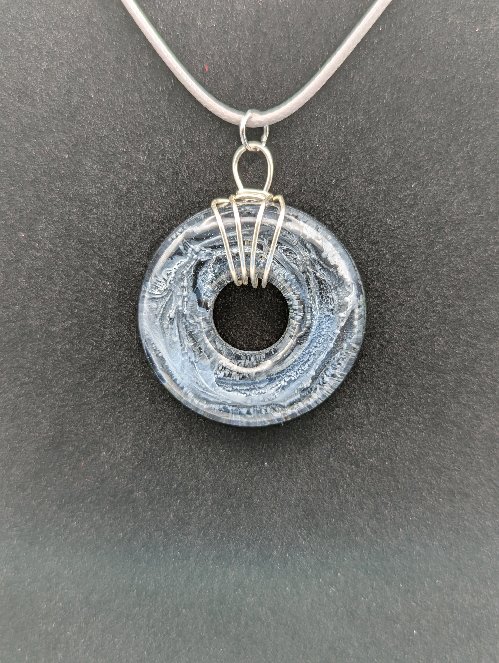 Wire Wrapped Donut Resin Pendant Necklace - Petri Effect with shades of black, white, & dark smokey bluish gray swirls. Resin Necklace on a waxed cotton cord.