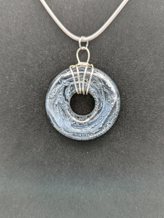 Wire Wrapped Donut Resin Pendant Necklace - Petri Effect with shades of black, white, & dark smokey bluish gray swirls. Resin Necklace on a waxed cotton cord.
