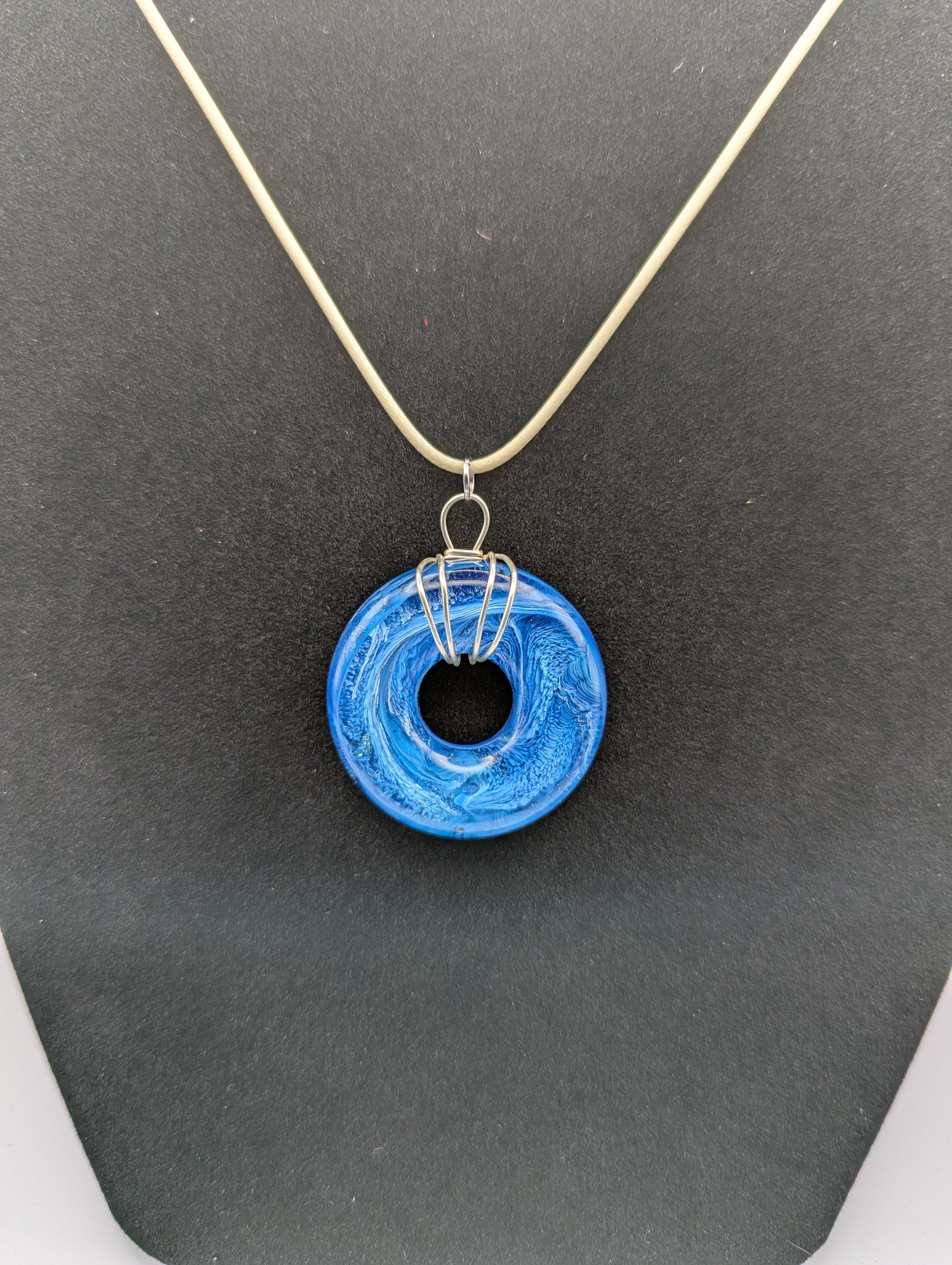 Wire Wrapped Donut Resin Pendant Necklace - Petri Effect with shades of blue. Resin Necklace on a waxed cotton cord.