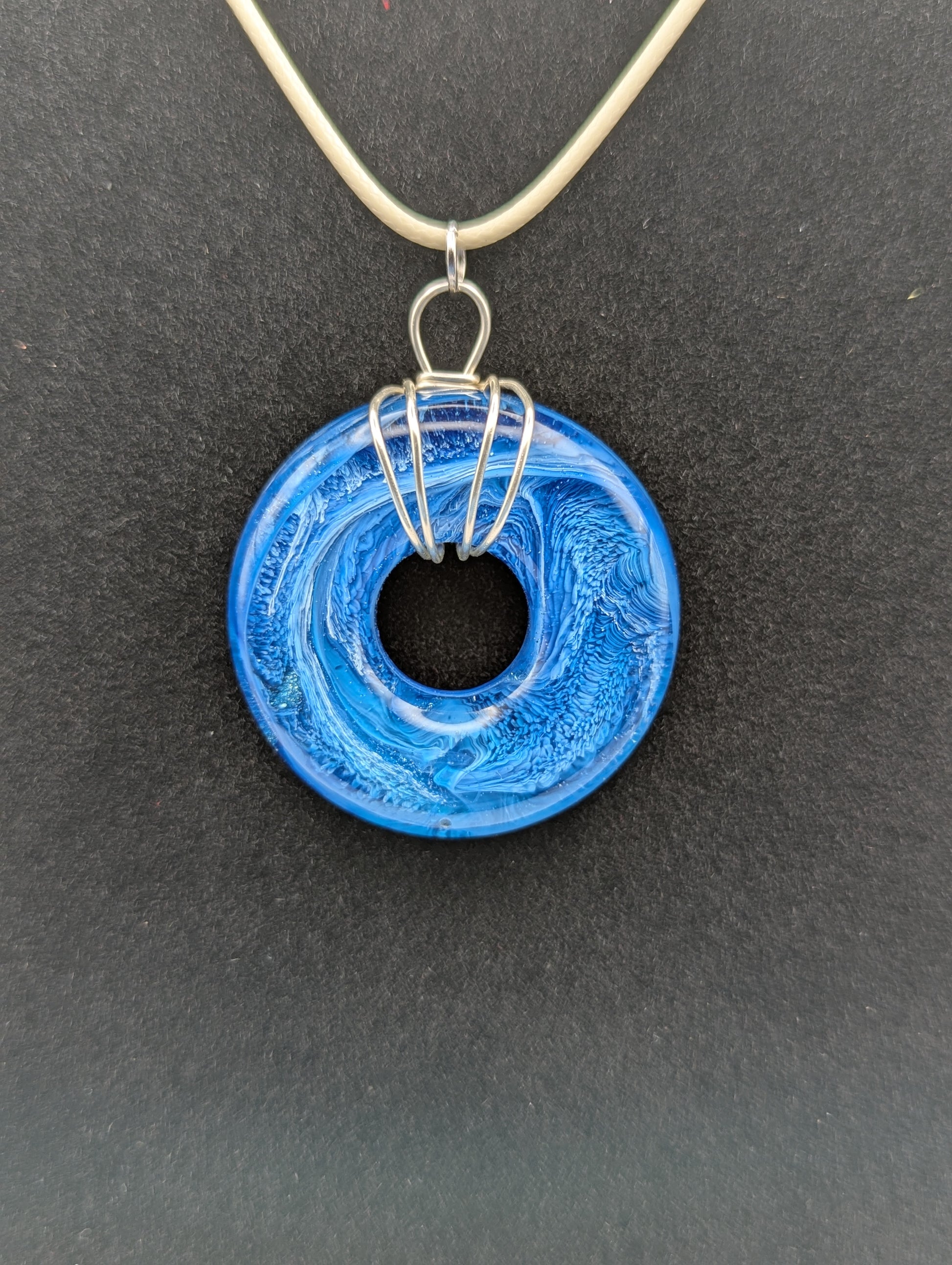 Wire Wrapped Donut Resin Pendant Necklace - Petri Effect with shades of blue. Resin Necklace on a waxed cotton cord.