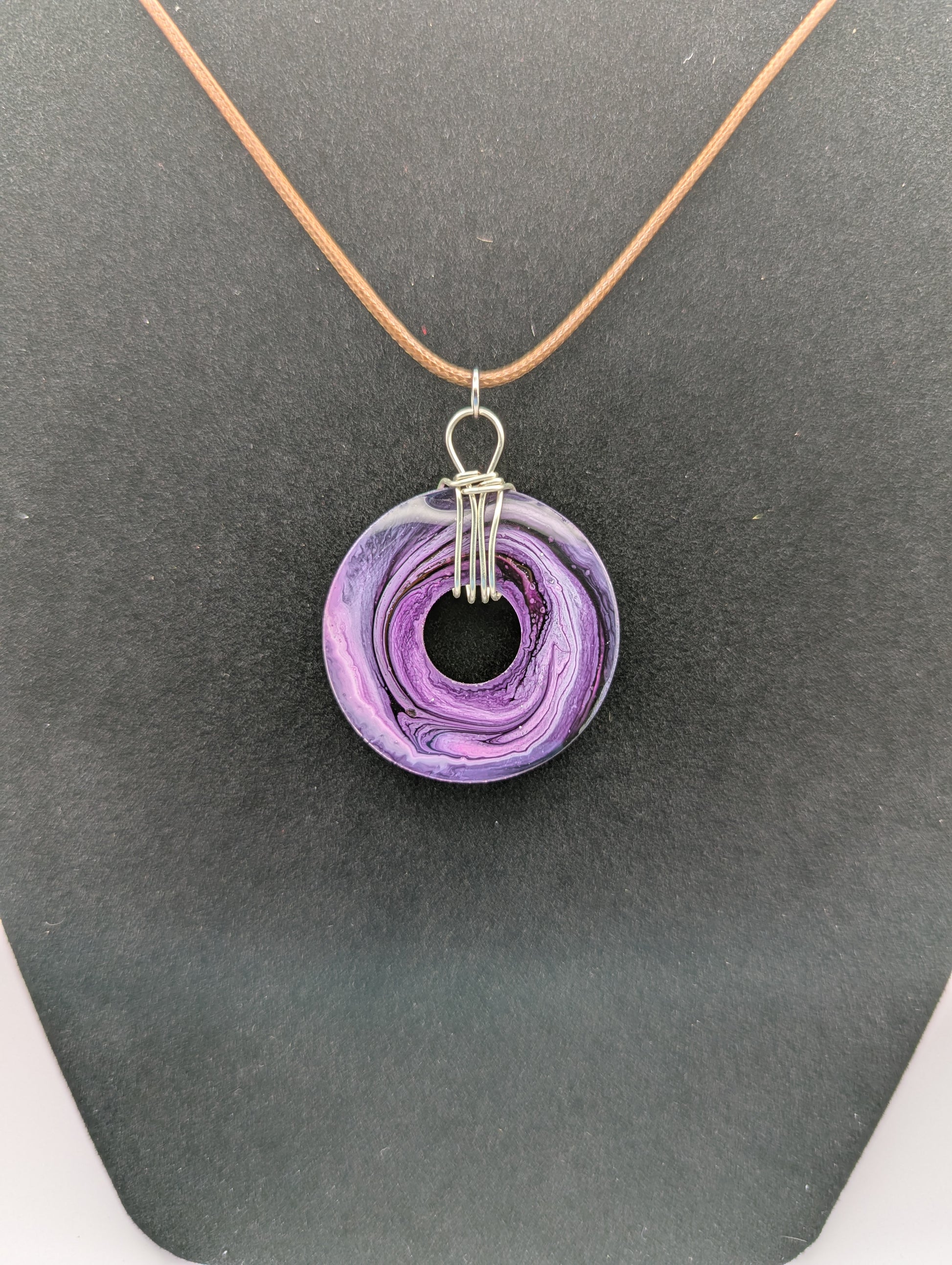 Back view of Wire Wrapped Donut Resin Pendant Necklace - Petri Effect with shades of purple & pink. Resin Necklace on a waxed cotton cord.