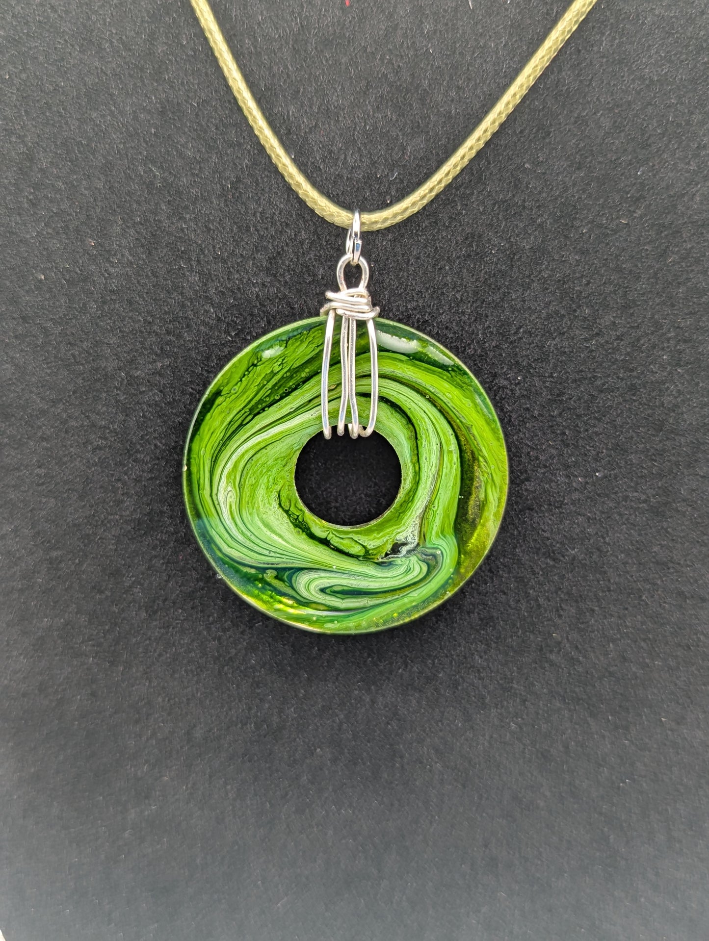 Back view of Wire Wrapped Donut Resin Pendant Necklace - Petri Effect with shades of green. Resin Necklace on a waxed cotton cord.