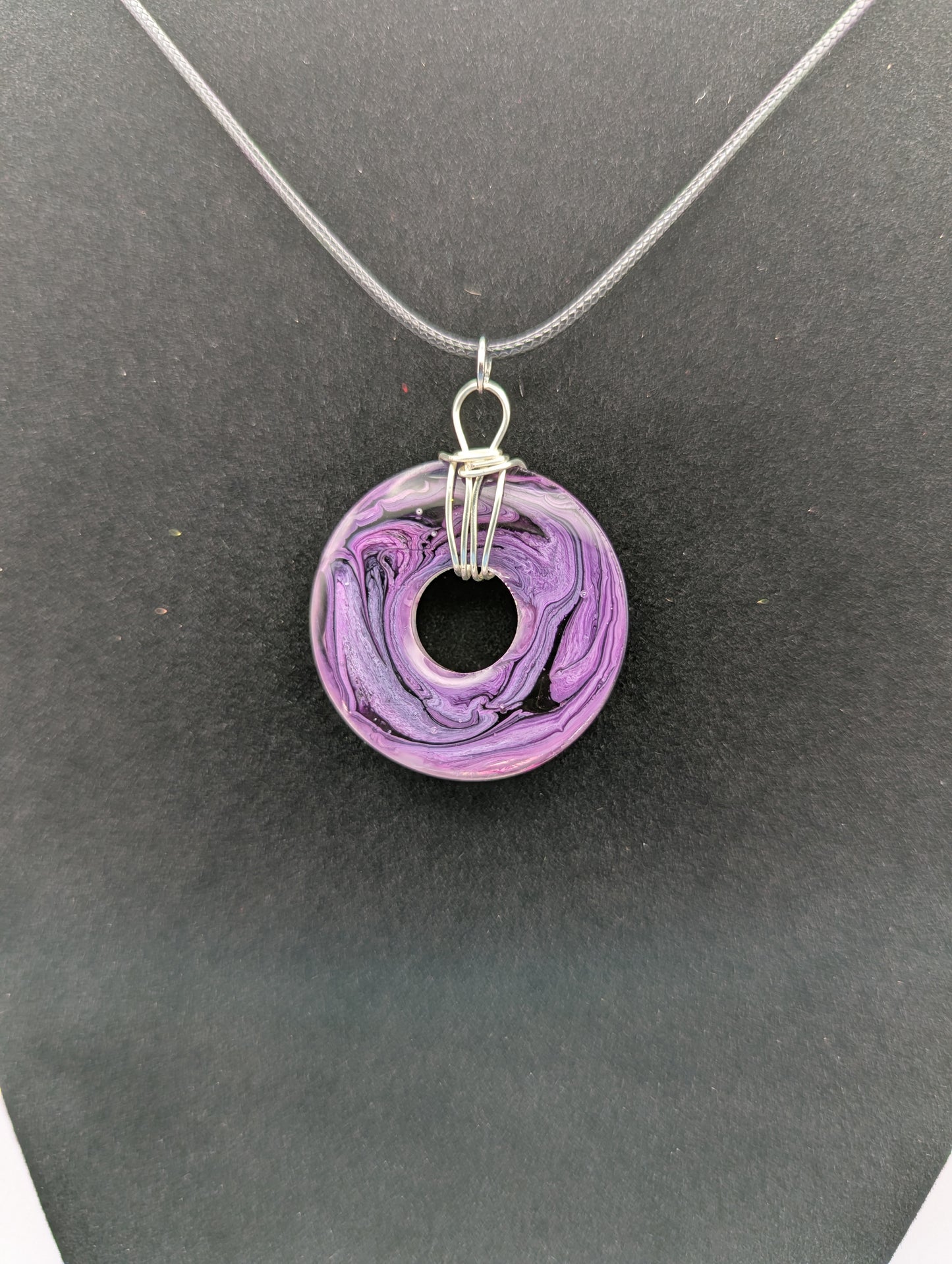 Back view of Wire Wrapped Donut Resin Pendant Necklace - Petri Effect with shades of purple. Resin Necklace on a waxed cotton cord.