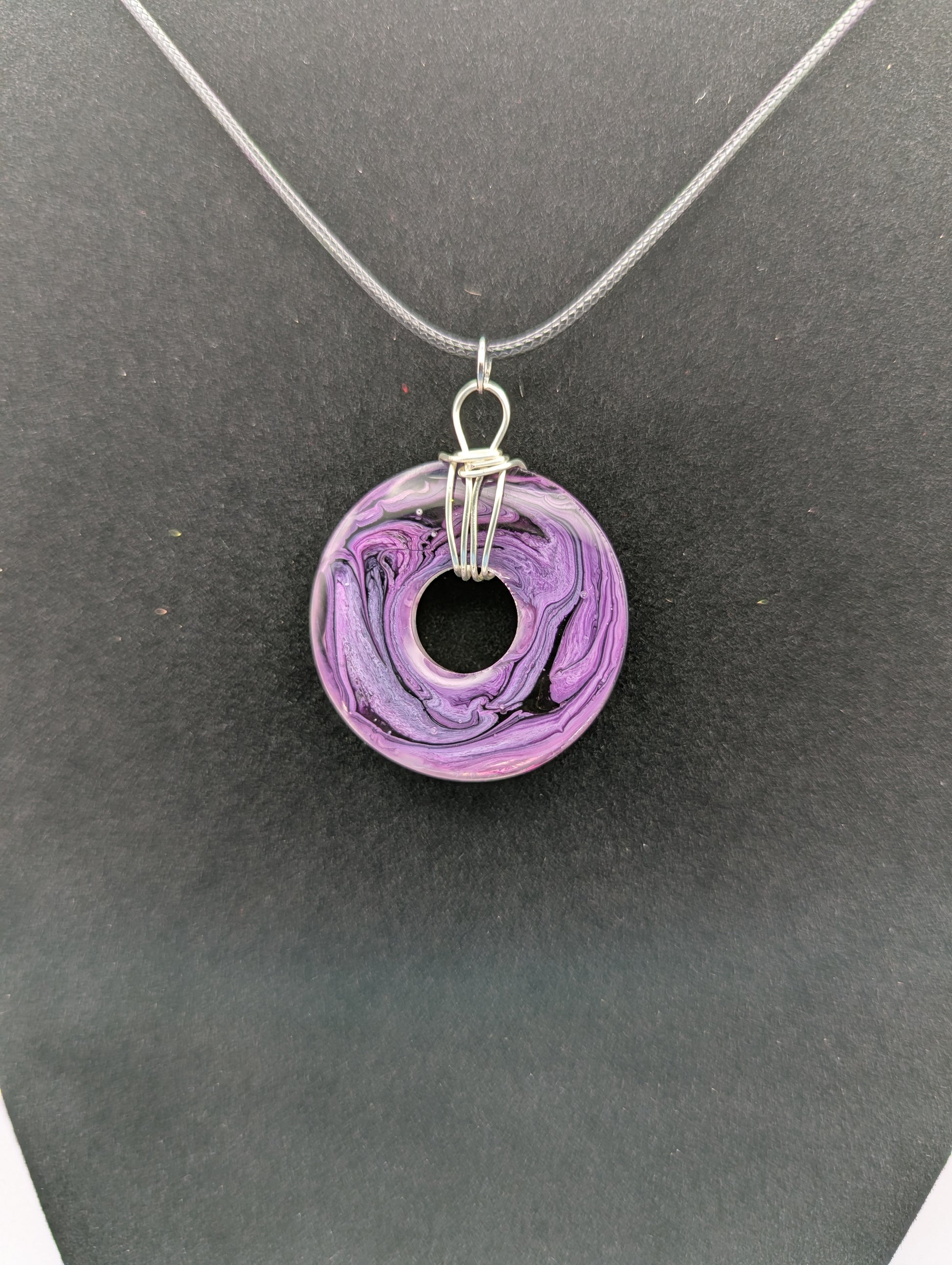 Back view of Wire Wrapped Donut Resin Pendant Necklace - Petri Effect with shades of purple. Resin Necklace on a waxed cotton cord.