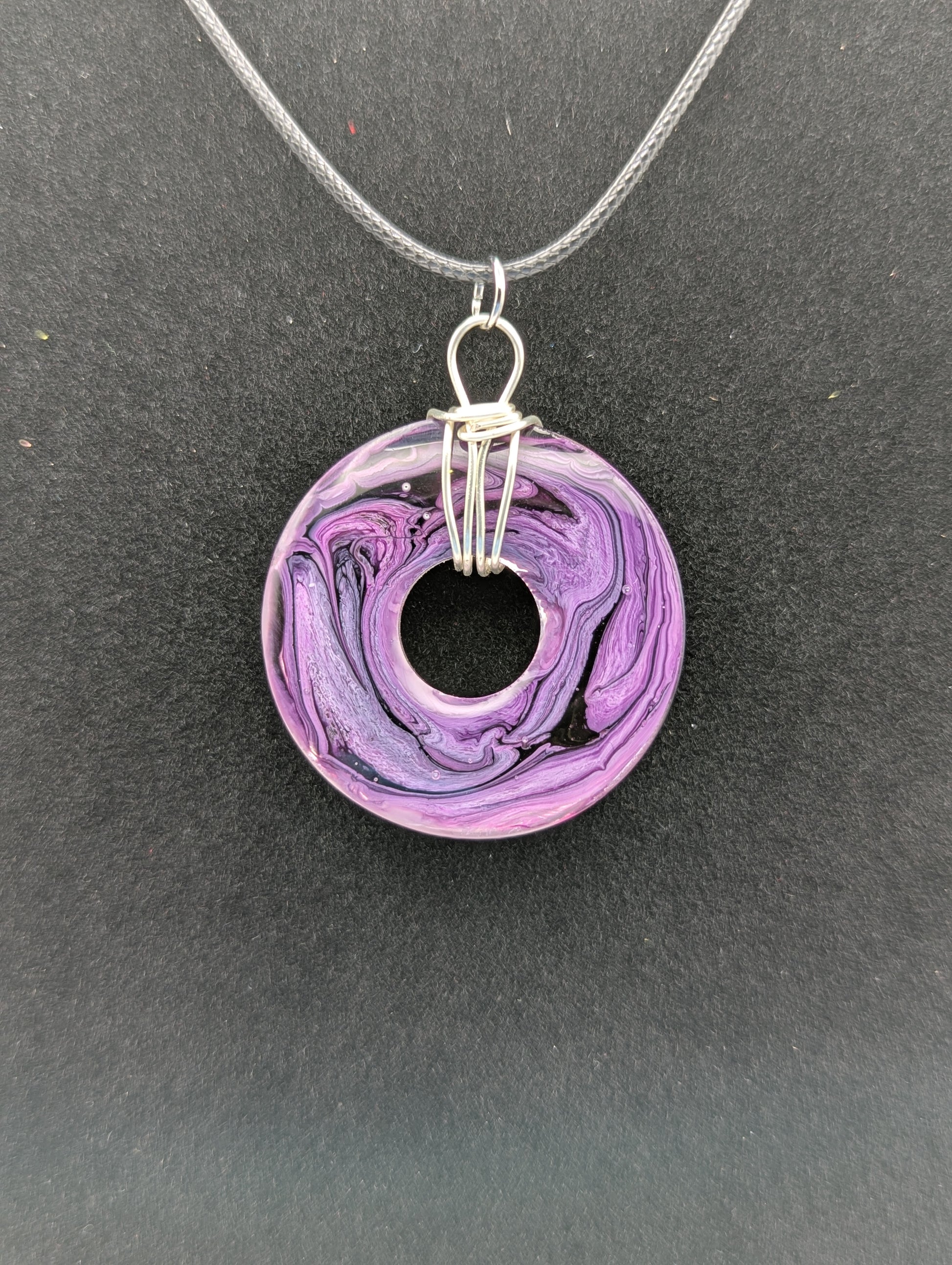 Back view of Wire Wrapped Donut Resin Pendant Necklace - Petri Effect with shades of purple. Resin Necklace on a waxed cotton cord.