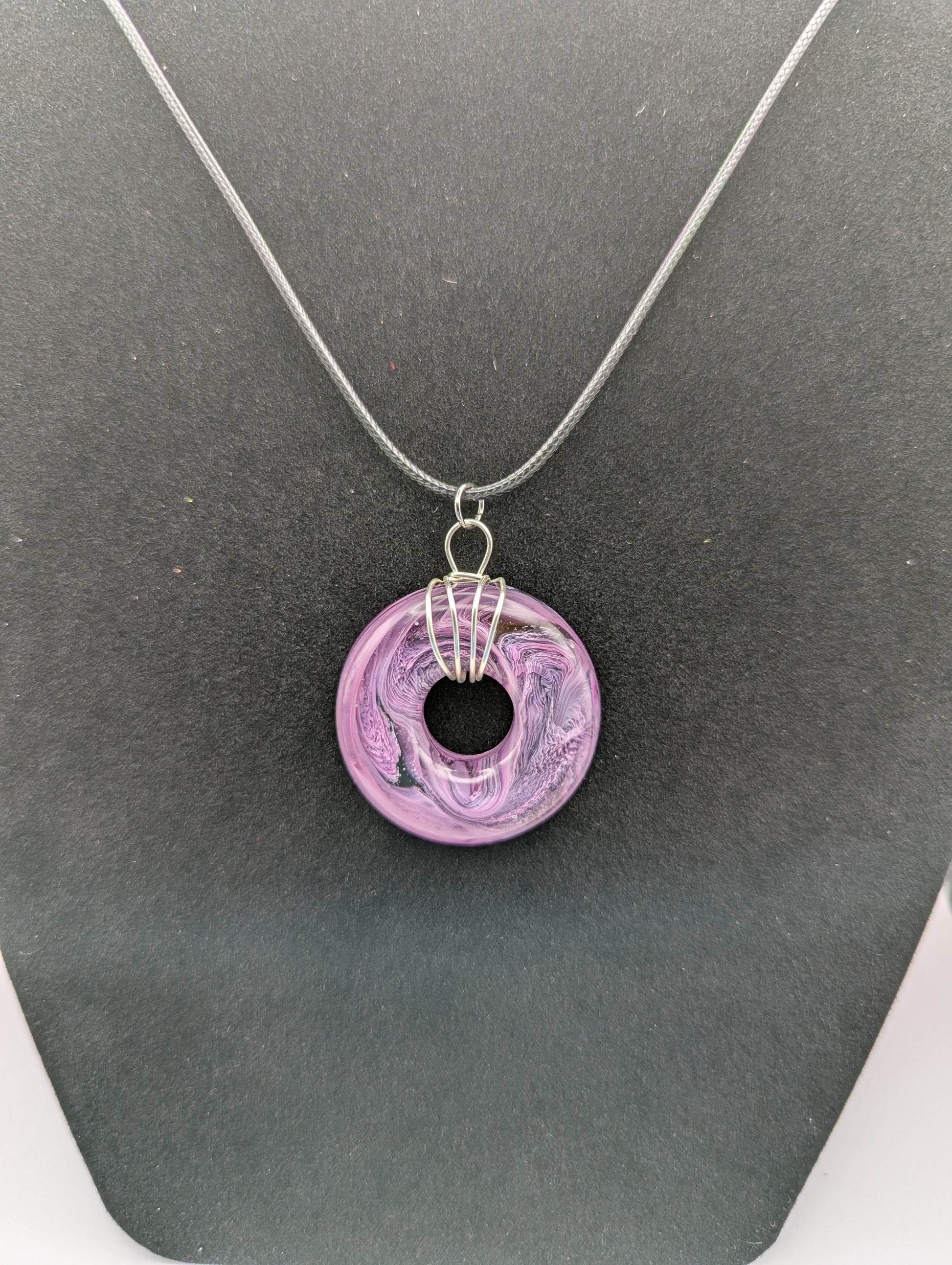 Wire Wrapped Donut Resin Pendant Necklace - Petri Effect with shades of purple. Resin Necklace on a waxed cotton cord.