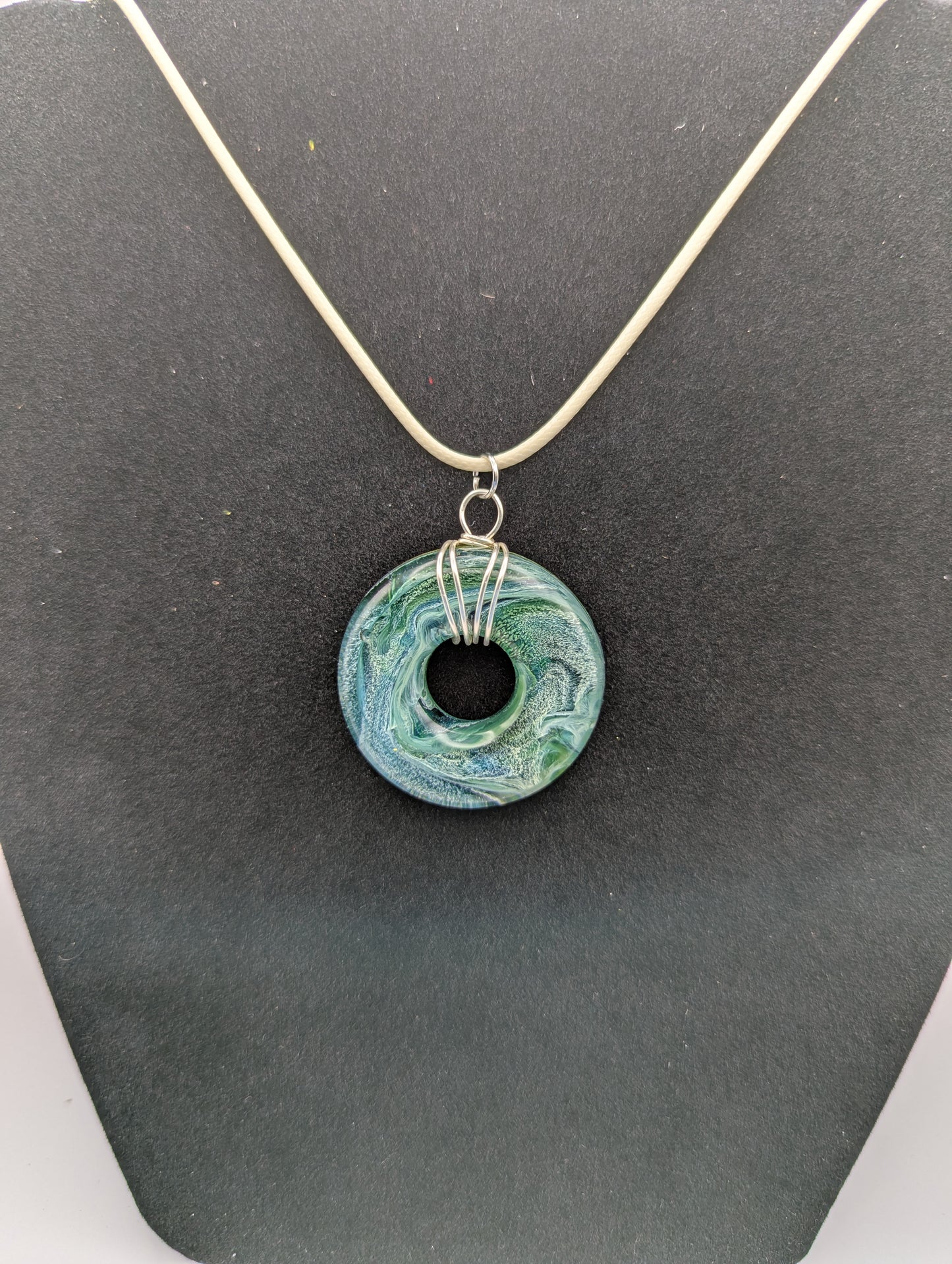 Wire Wrapped Donut Resin Pendant Necklace - Petri Effect with shades of blue, green, & yellow swirls. Resin Necklace on a waxed cotton cord.