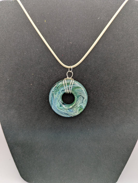 Wire Wrapped Donut Resin Pendant Necklace - Petri Effect with shades of blue, green, & yellow swirls. Resin Necklace on a waxed cotton cord.