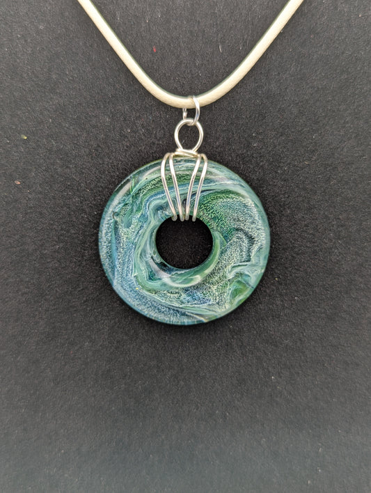 Wire Wrapped Donut Resin Pendant Necklace - Petri Effect with shades of blue, green, & yellow swirls. Resin Necklace on a waxed cotton cord.